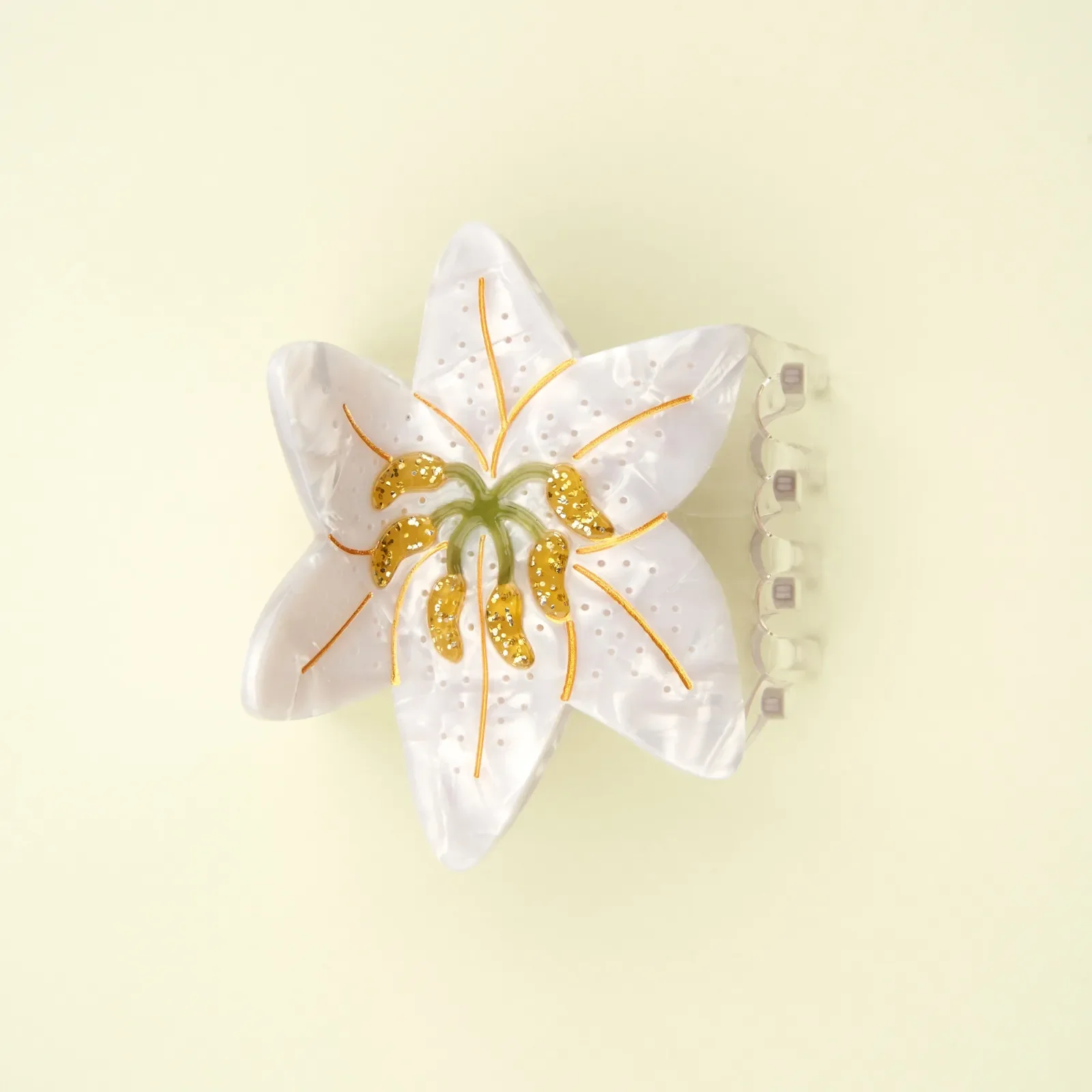 Coucou Suzette Lily Hair Claw in glossy cellulose acetate, an elegant French flower hair accessory curated by Goosebump.