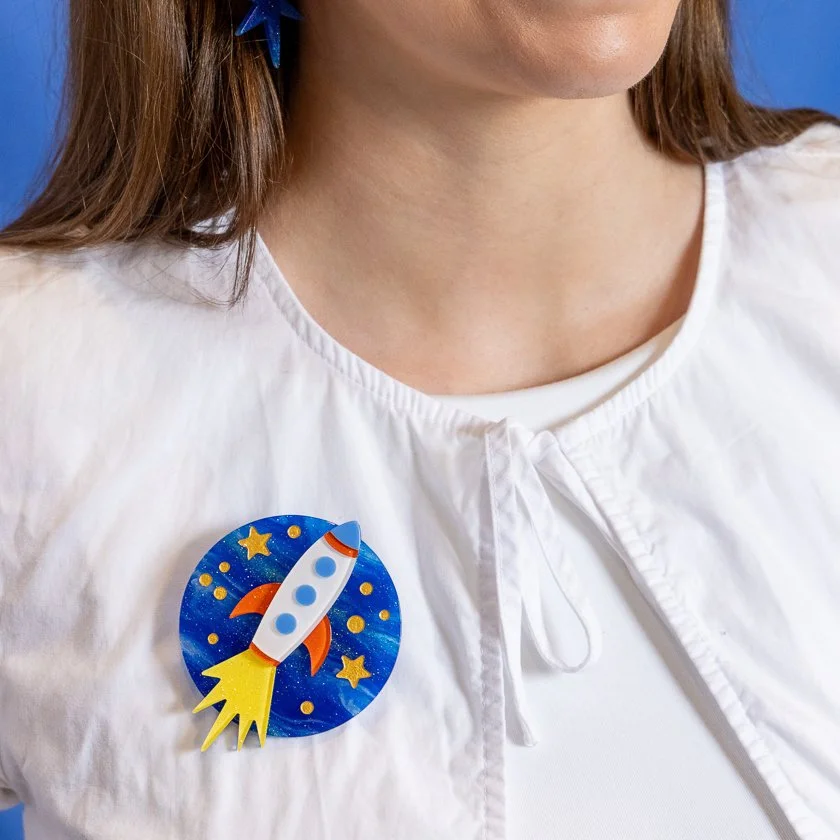 Erstwilder Blast Off! Brooch featuring a layered rocket design with a bright, space-inspired look.