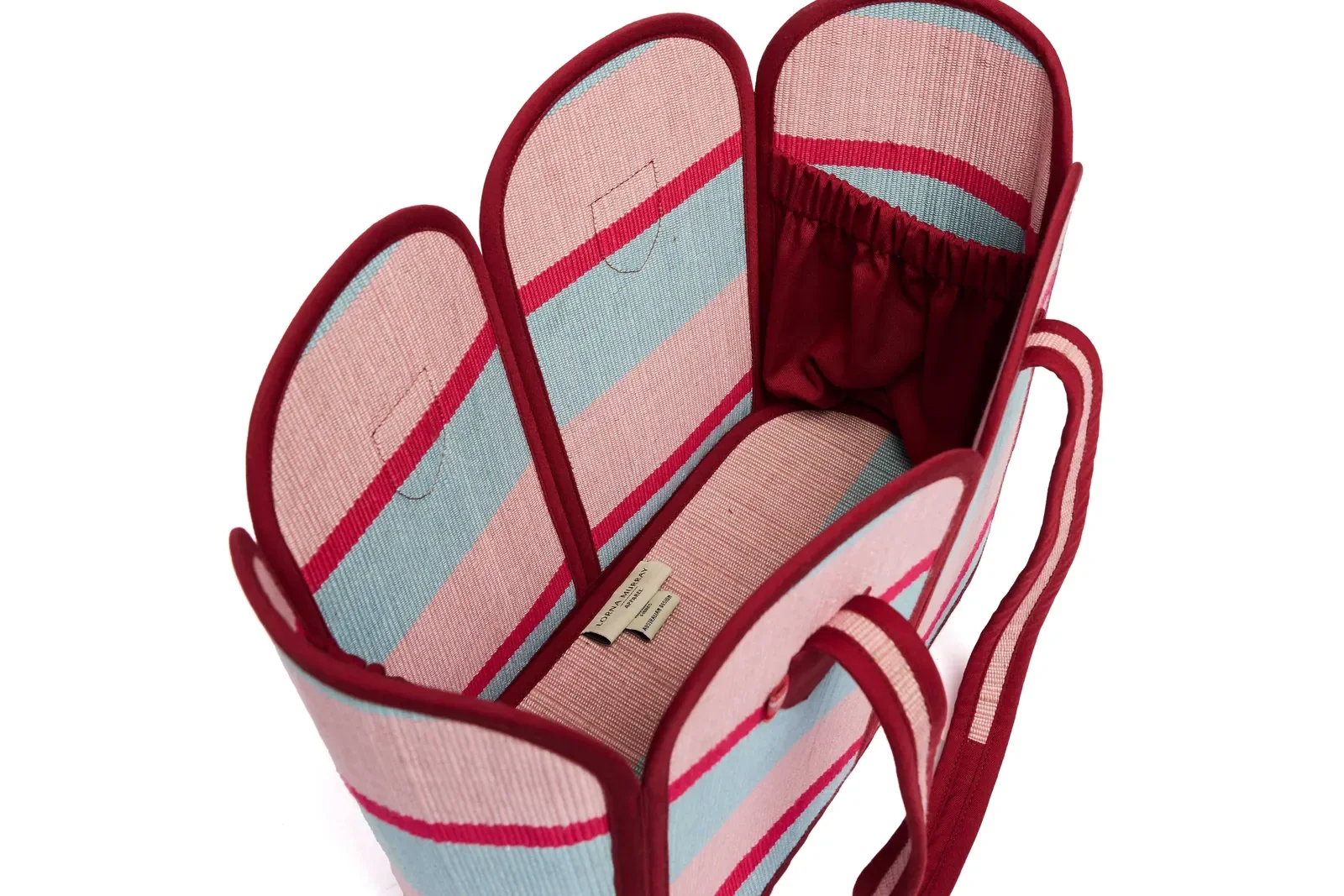 Side profile of the Lorna Murray Escape Vacation Tote highlighting its structured woven silhouette.