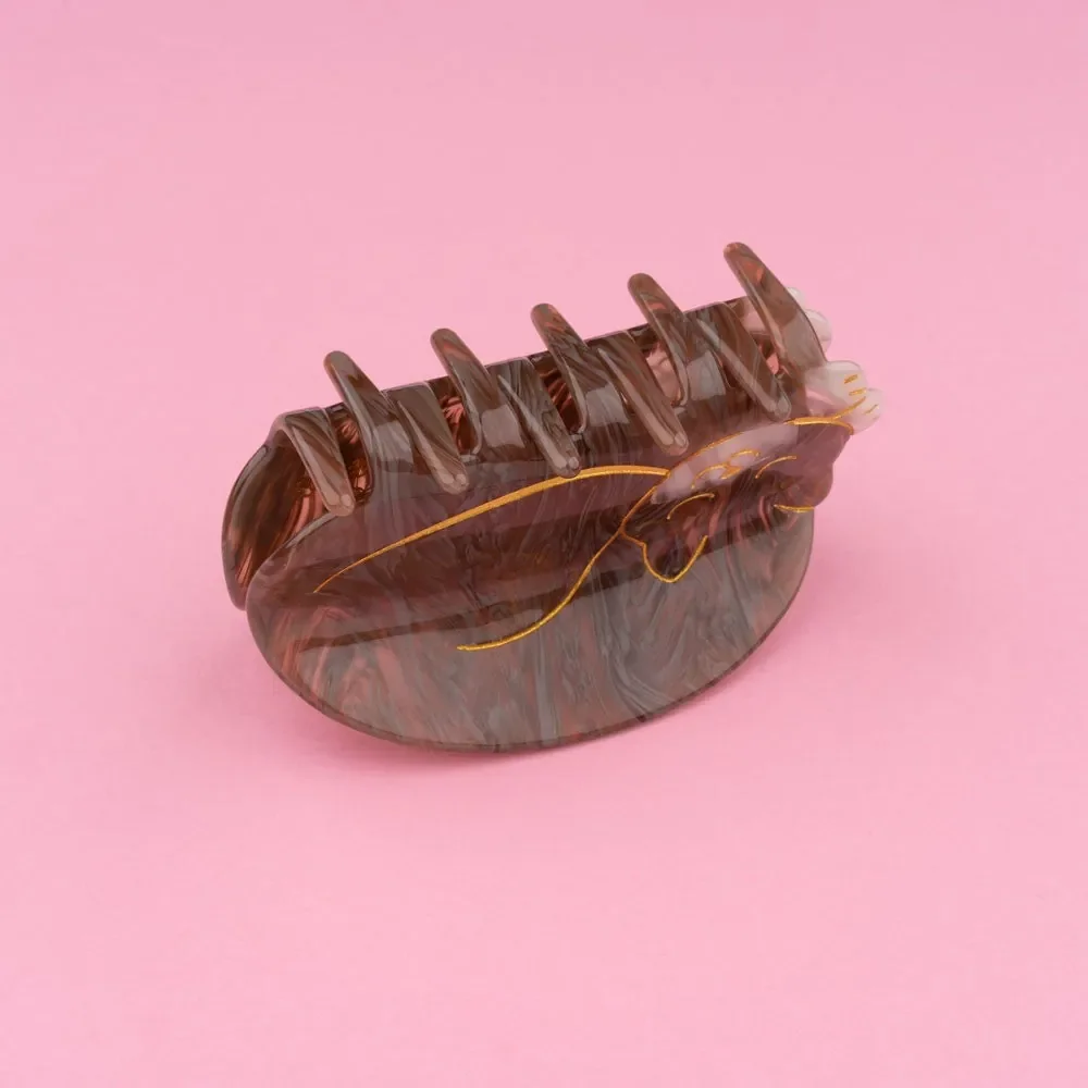 Sleeping cat hair claw by Coucou Suzette in glossy cellulose acetate.