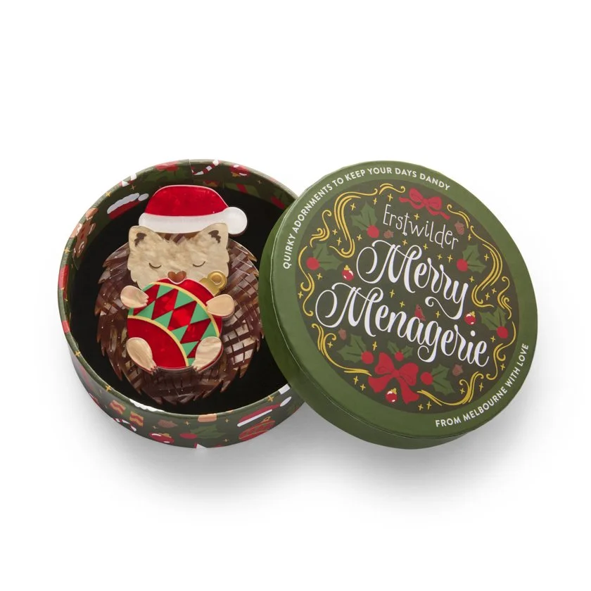 Erstwilder Hannah the Hedgehog Christmas brooch curled with festive bauble and Santa hat. Limited batch, exclusive in Hong Kong at Goosebump.