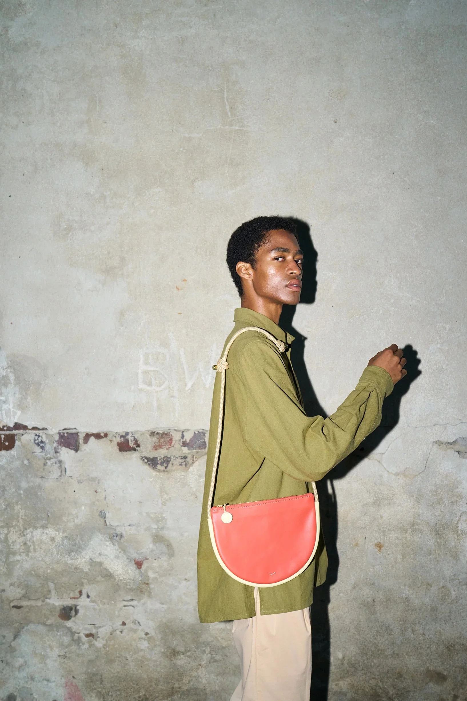 Selene Bag in Lobster Red and Butter – handcrafted leather sling bag with crescent shape and adjustable rope strap, designed by Project Dyad