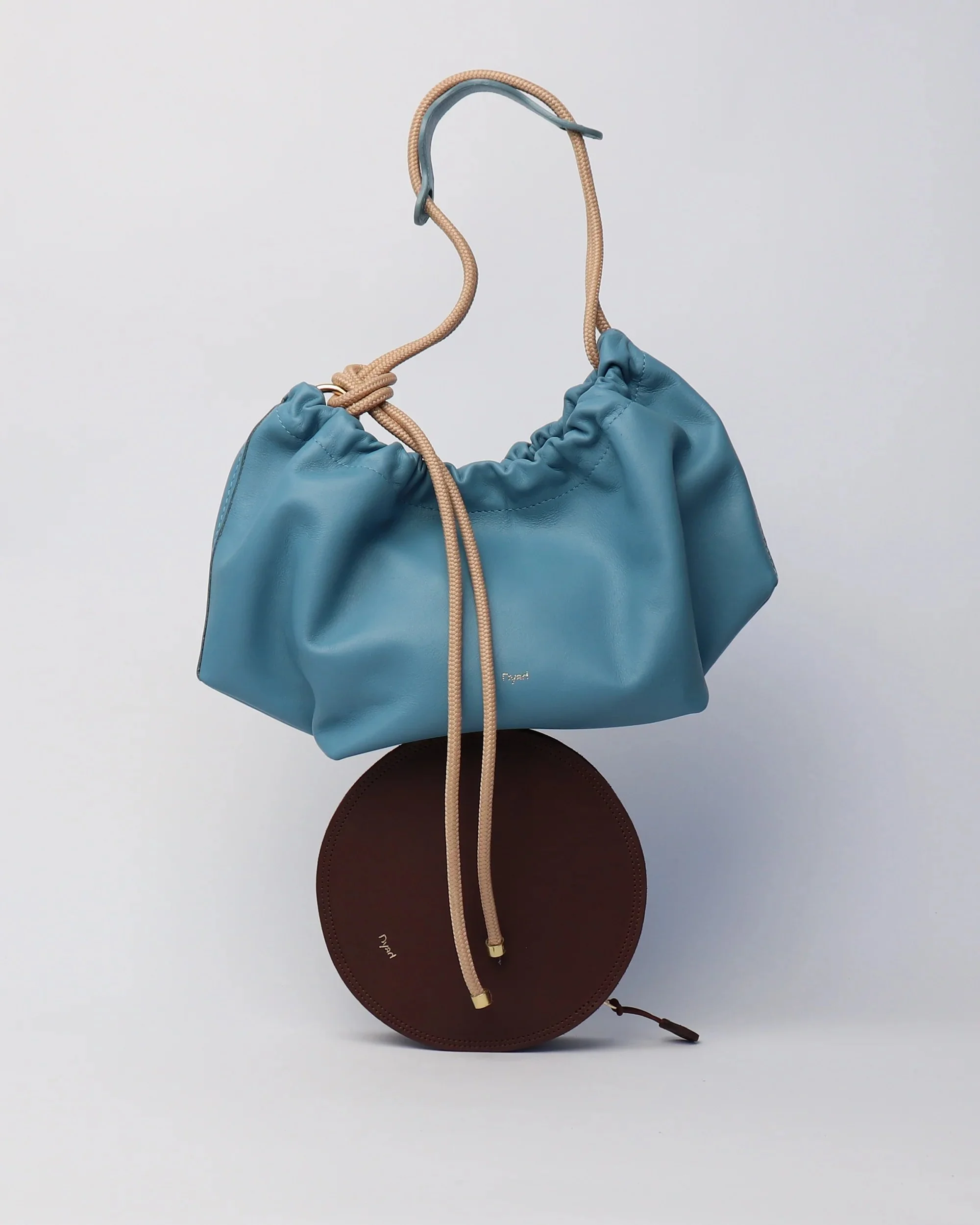 Sky Blue leather Flora Bag with tulip-inspired shape and artisan rope strap by Project Dyad, made in Cape Town.