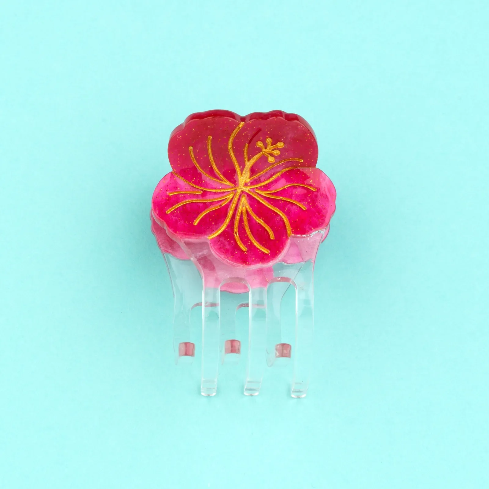 Coucou Suzette Mini Hibiscus Hair Claw in acrylic, a cheerful French flower hair accessory curated by Goosebump.