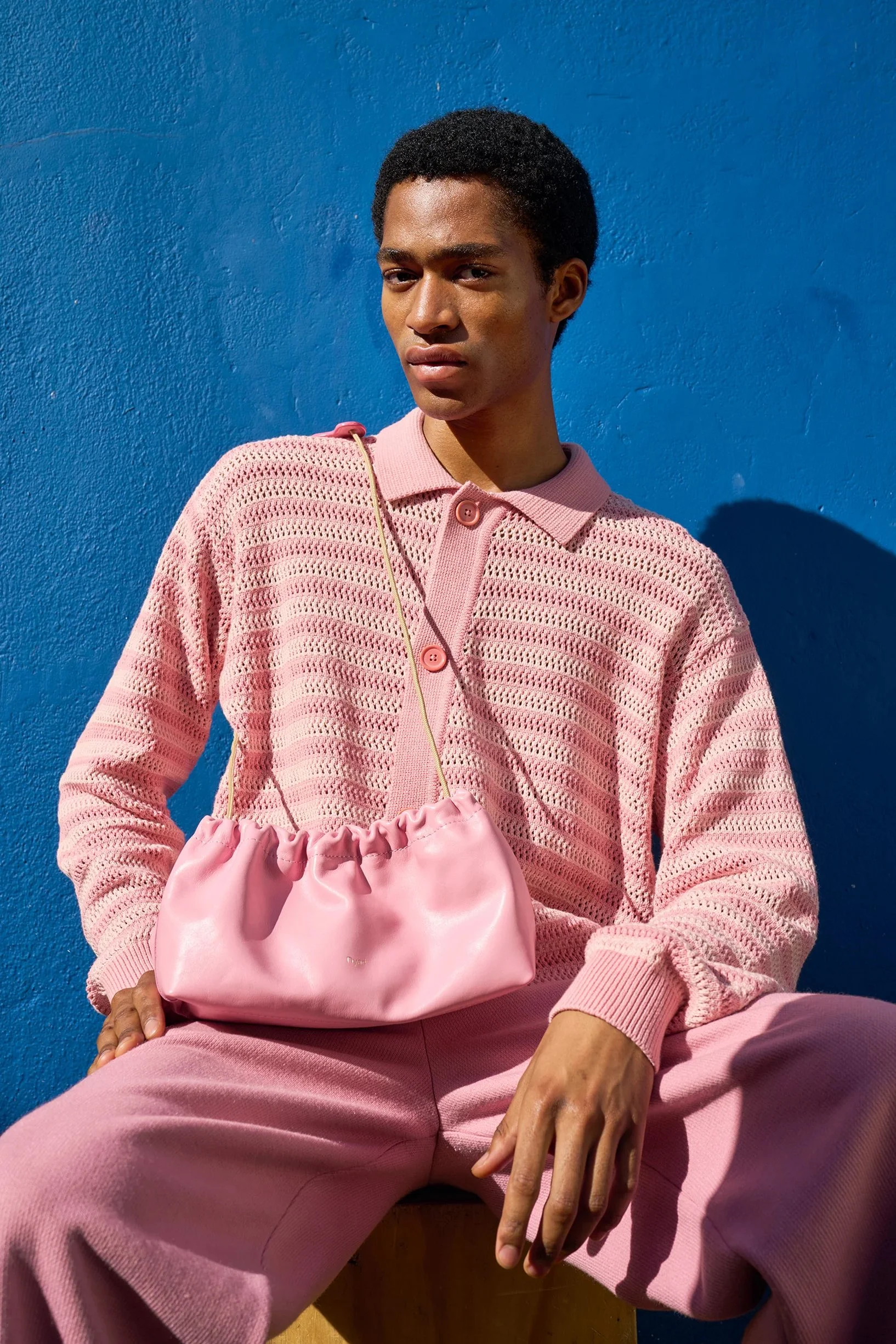 Candy pink pleated canvas shoulder bag by Project Dyad, featuring a sculptural silhouette and handcrafted detail.