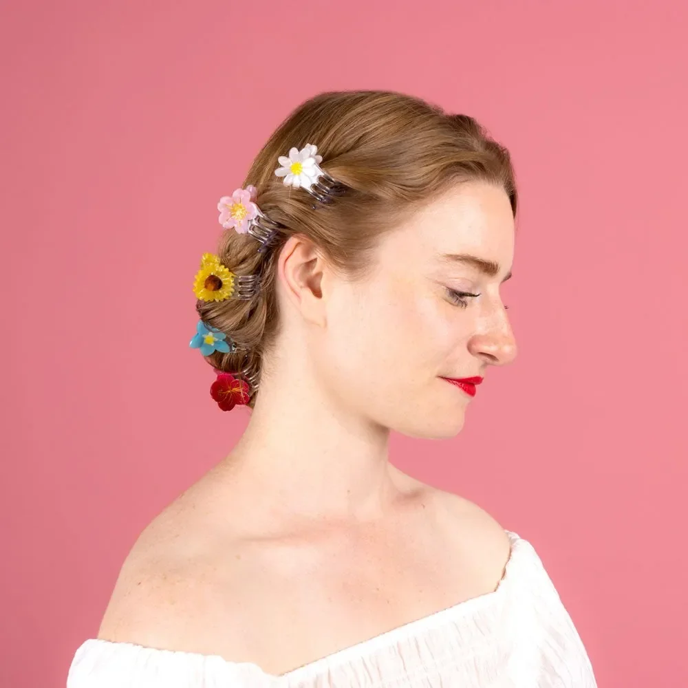 Coucou Suzette Mini Daisy Hair Claw in glossy cellulose acetate, a sweet French flower hair accessory curated by Goosebump.