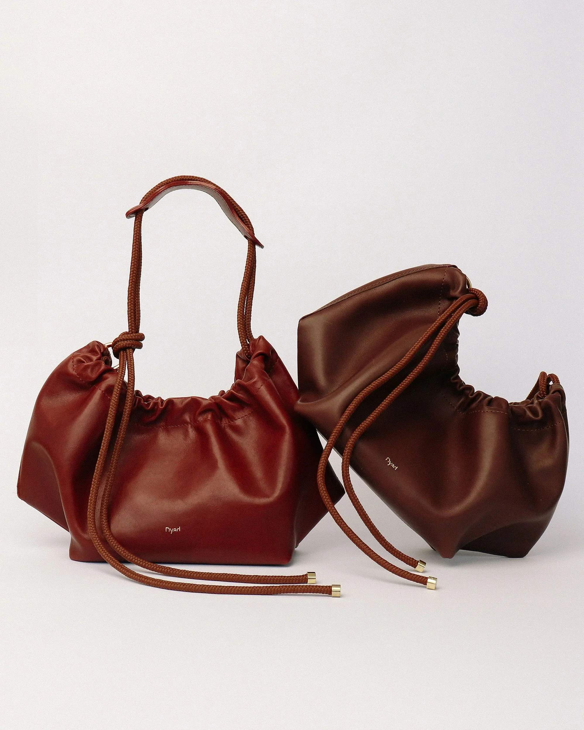Brown Flora Bag with tulip-inspired shape and rope strap, handmade in Cape Town using full-grain leather and Italian magnetic closure.