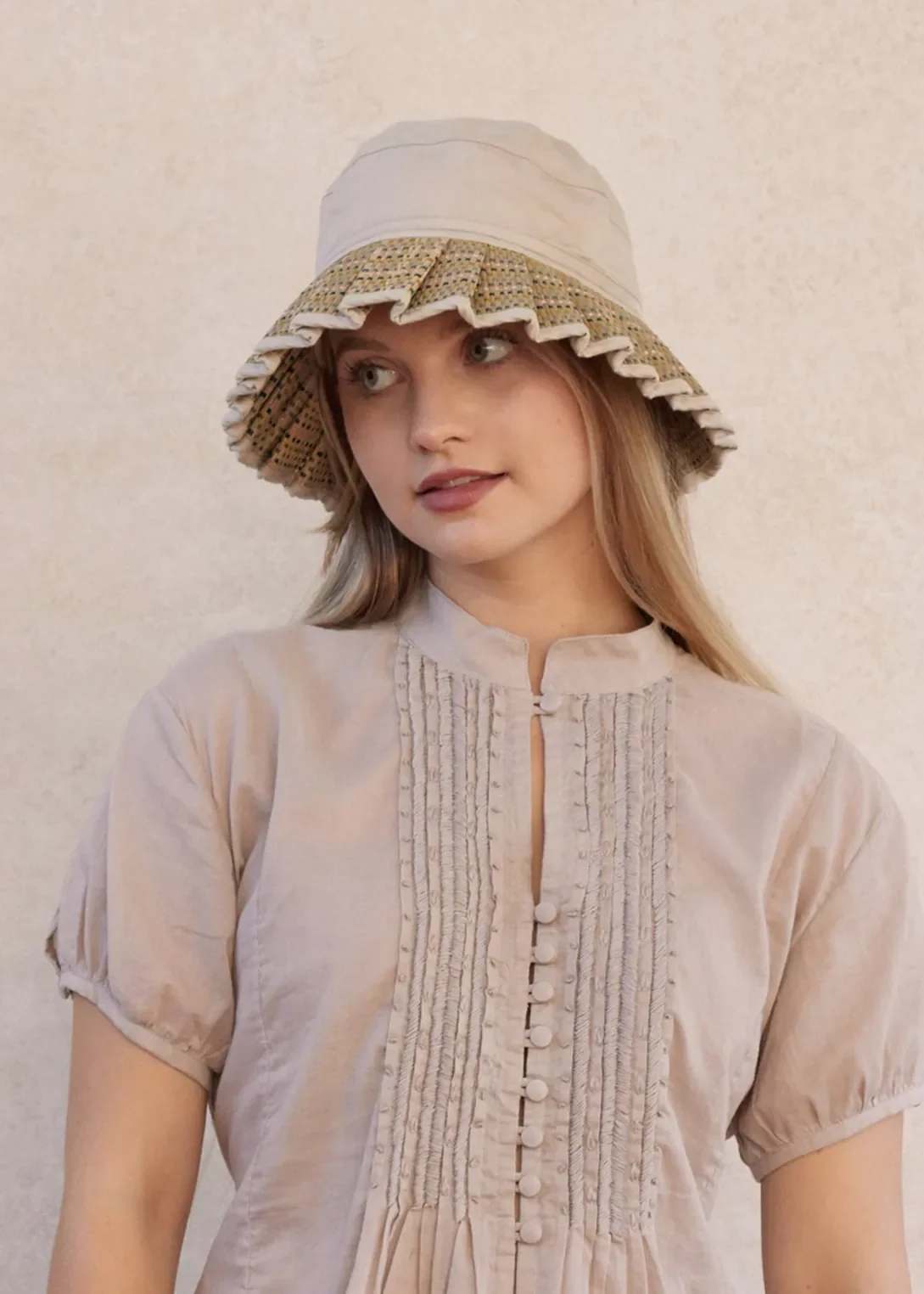 Model wearing the Lorna Murray Sandbar Oasis Hat, showcasing its handcrafted woven design and certified UPF 50+ sun protection.