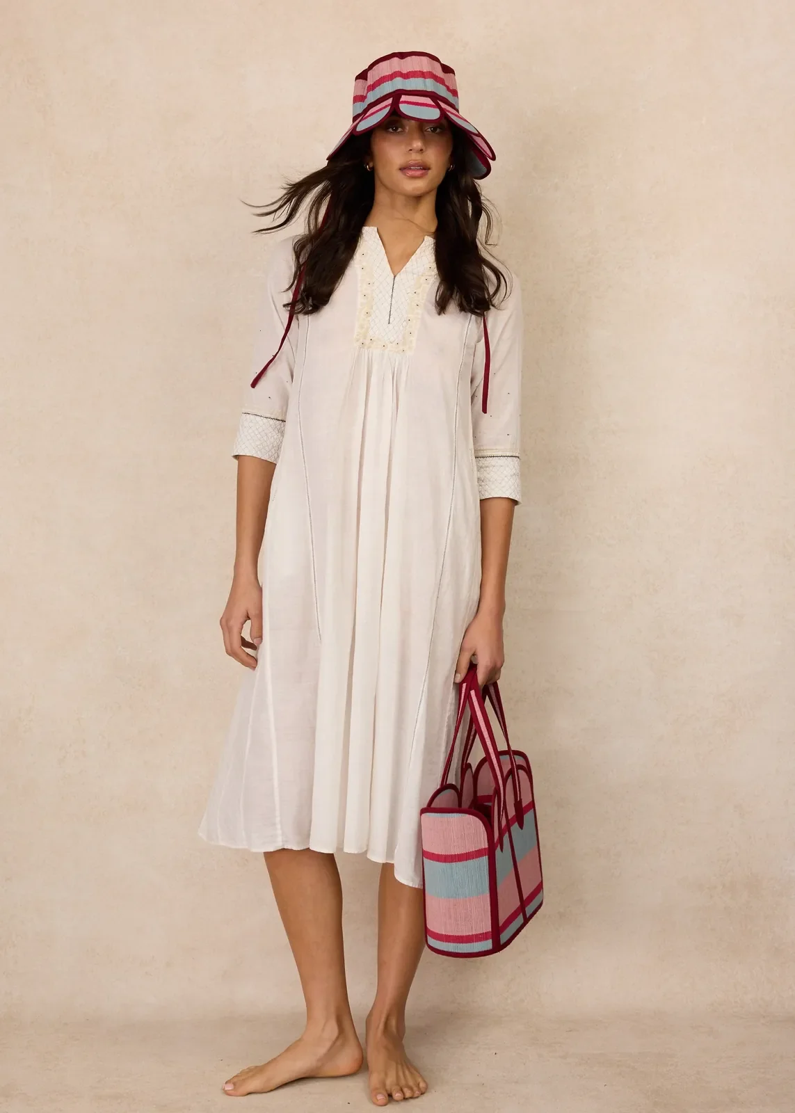 Model holding the Lorna Murray Escape Vacation Tote, showcasing its handcrafted woven design and generous everyday size.