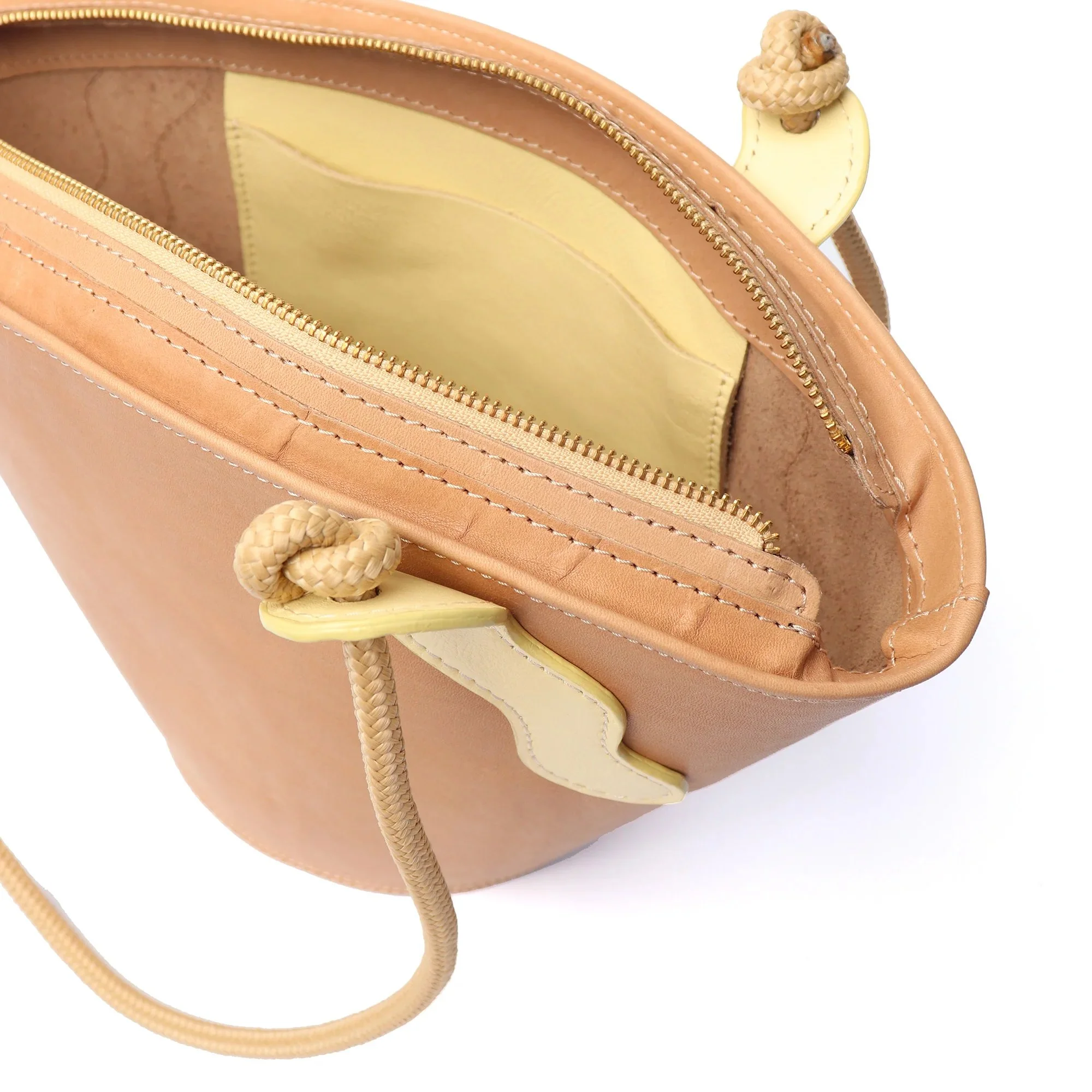Almond and butter yellow leather handbag by Project Dyad, featuring sculptural A-line shape and handcrafted Cape Town craftsmanship.