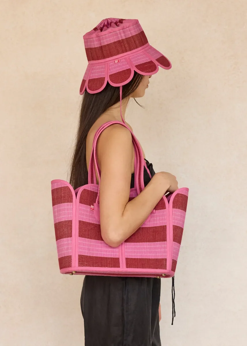 Lorna Murray Dragonfruit Summer Vacation Tote front view in handwoven natural grass fibres with pink and cherry red woven stripes.