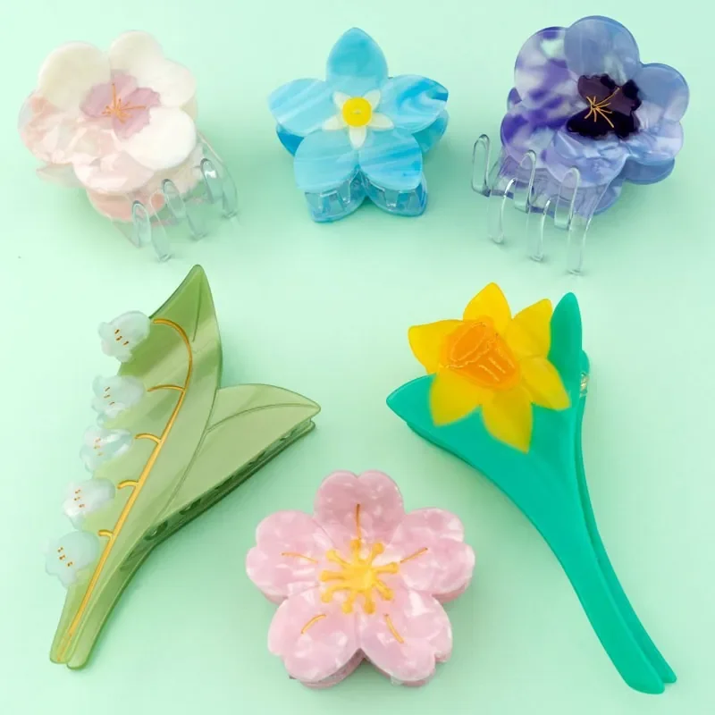 Coucou Suzette Forget-Me-Not Hair Claw in glossy cellulose acetate, a delicate French flower hair accessory curated by Goosebump.
