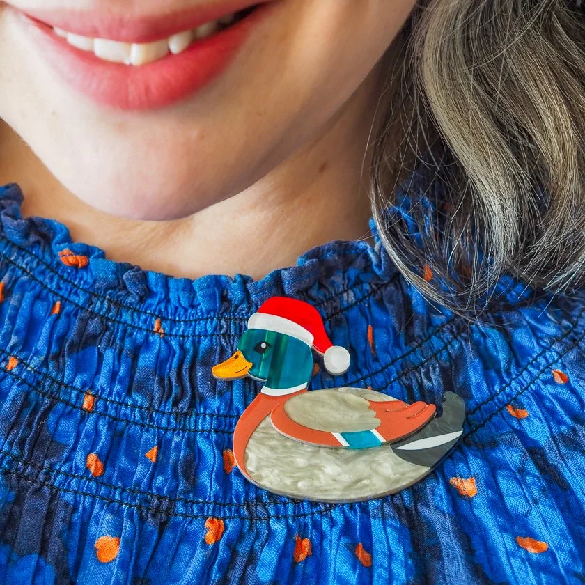 Erstwilder Daphne the Duck Christmas brooch with Santa hat and marbled feathers. Limited small-batch festive gift exclusive in Hong Kong at Goosebump.