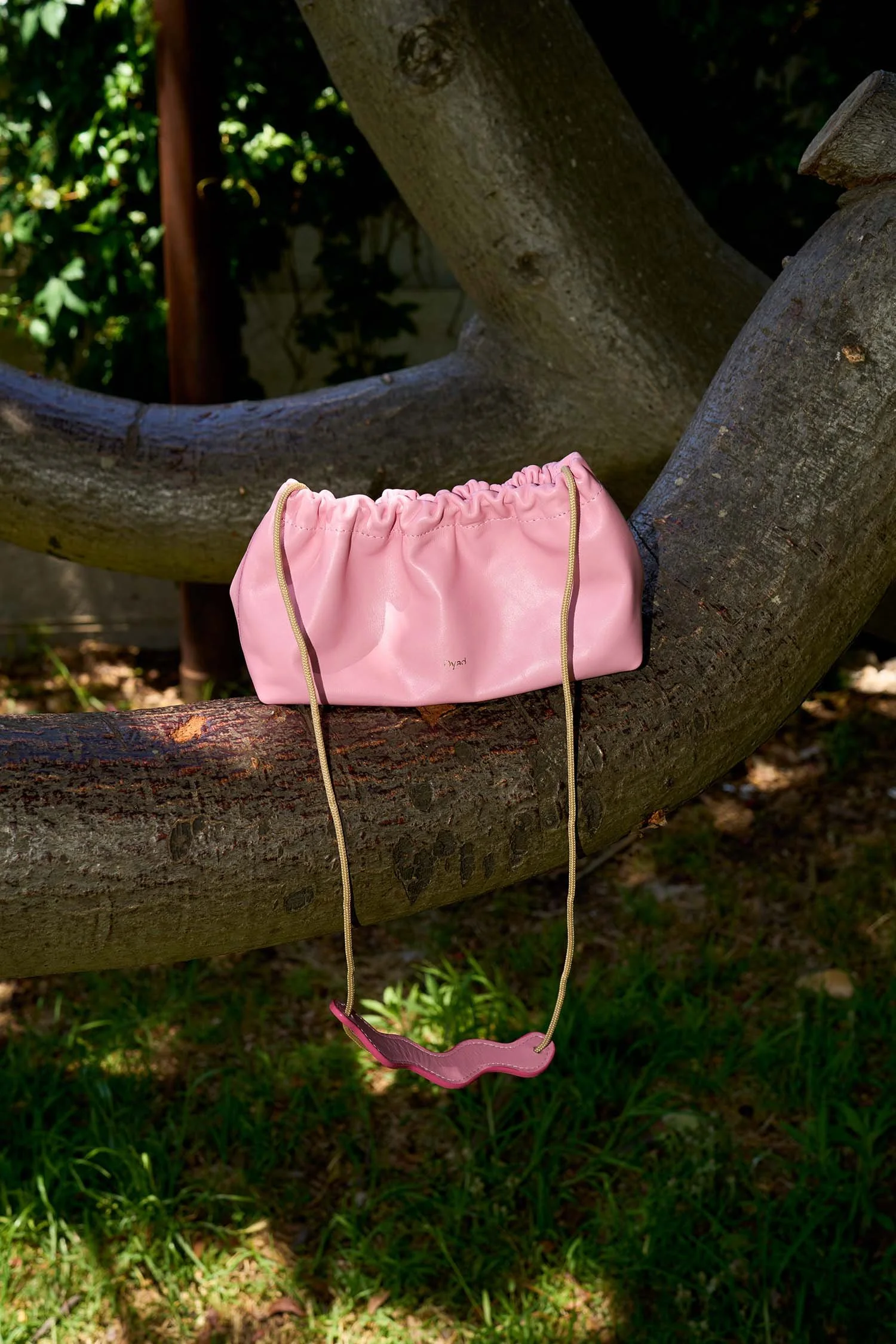 Candy pink pleated canvas shoulder bag by Project Dyad, featuring a sculptural silhouette and handcrafted detail.