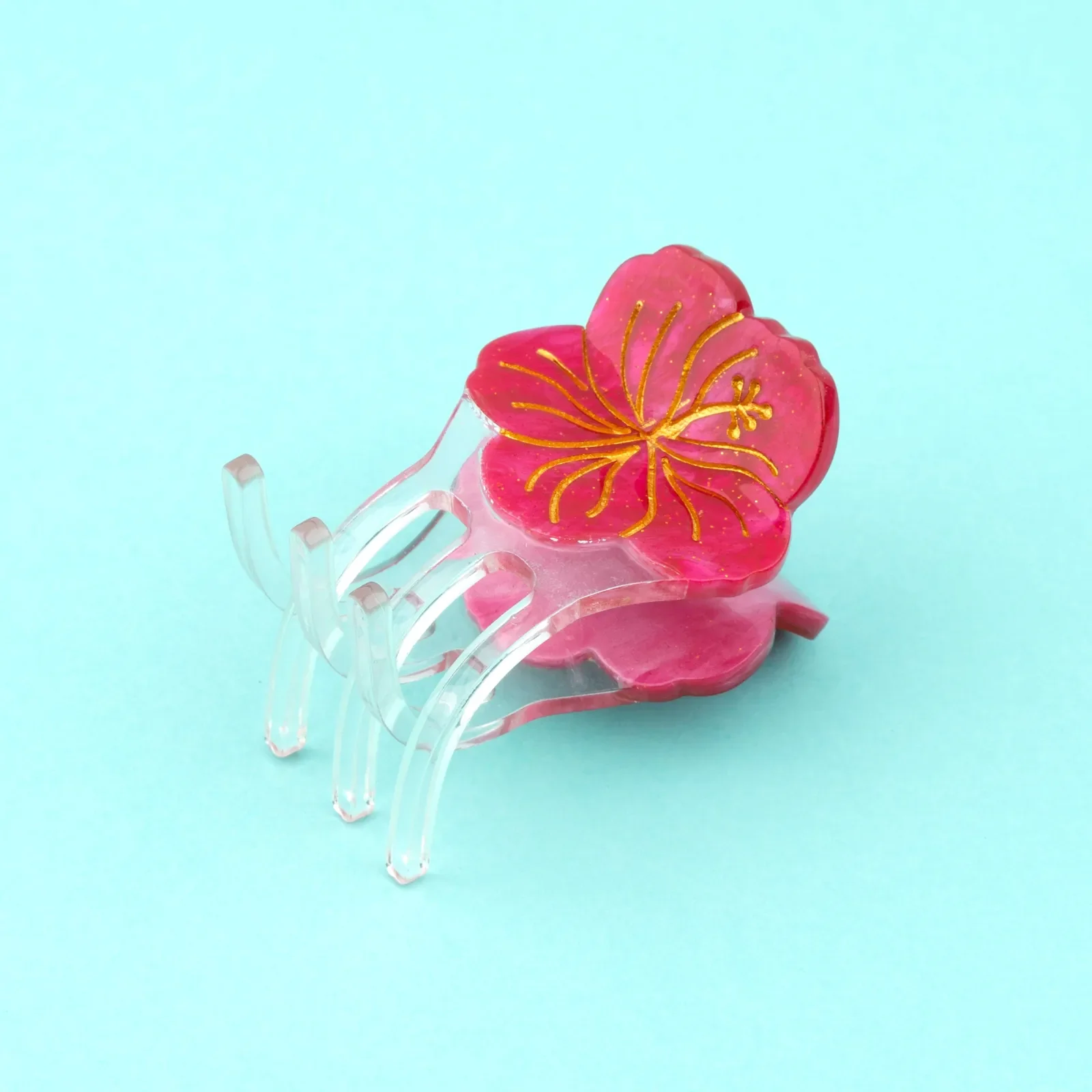 Coucou Suzette Mini Hibiscus Hair Claw in acrylic, a cheerful French flower hair accessory curated by Goosebump.