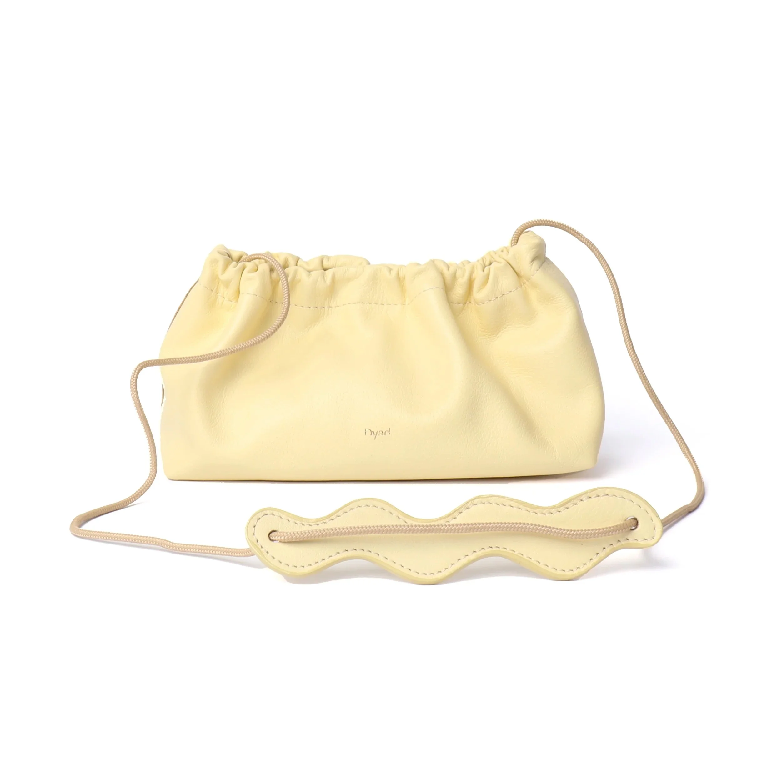 Wave Bag in butter yellow canvas with pleated silhouette and adjustable strap, handmade by Project Dyad in Cape Town.
