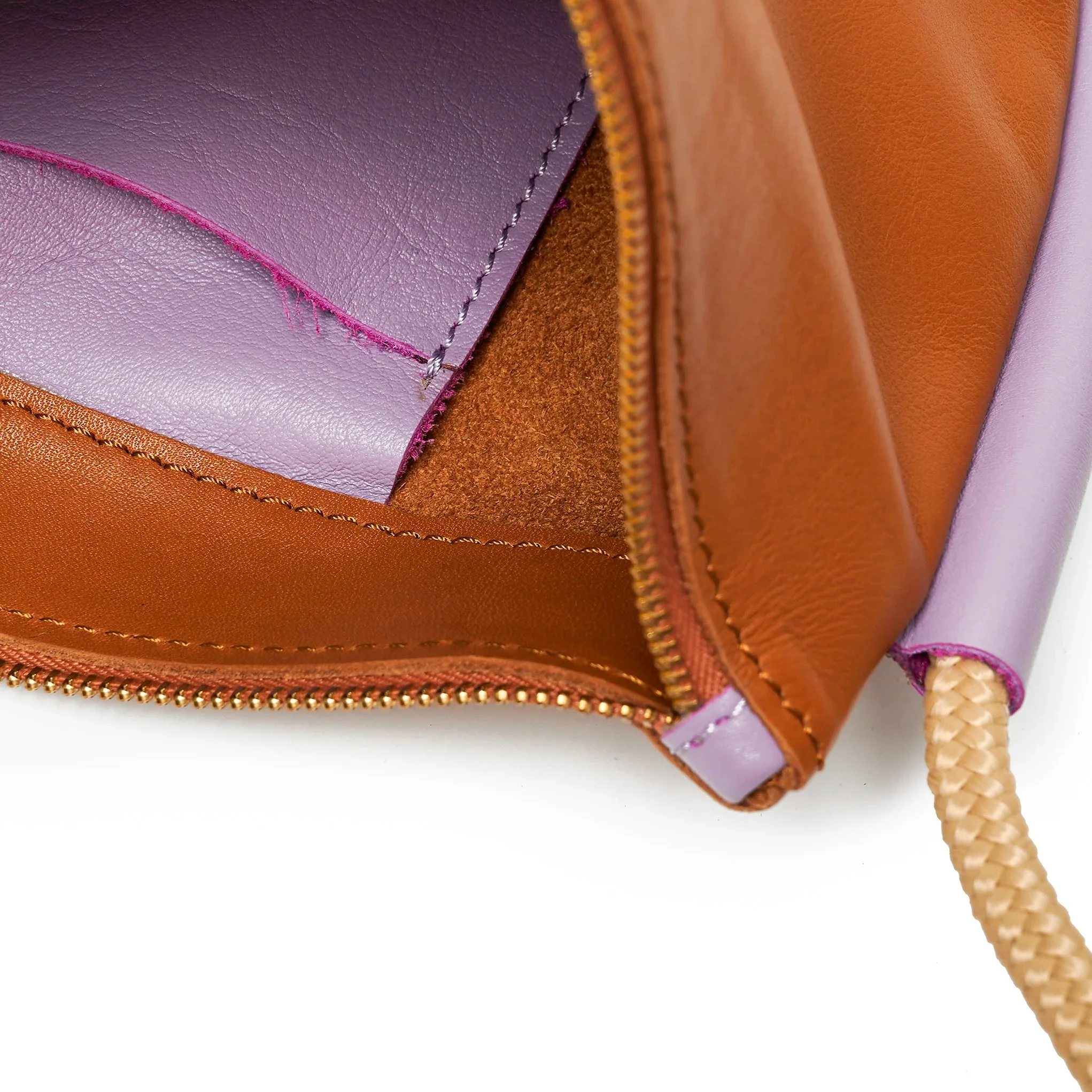 Selene Bag in tan and lilac colourway, sculptural folded silhouette with rope strap and short handles, handcrafted in South Africa.