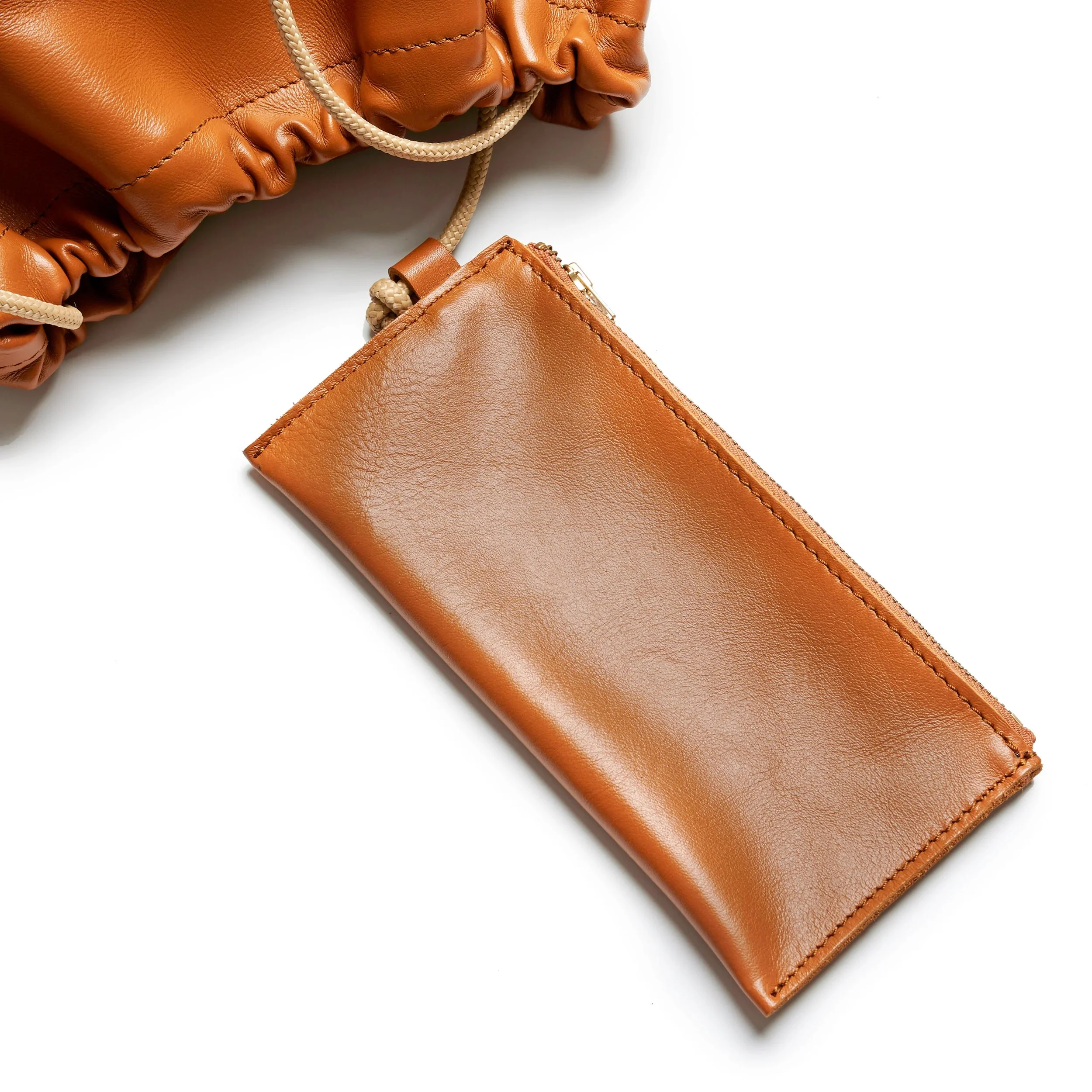 Wave Bag in tan deadstock canvas, crescent fold design with short handles and magnetic closure, handmade in Cape Town by Project Dyad.