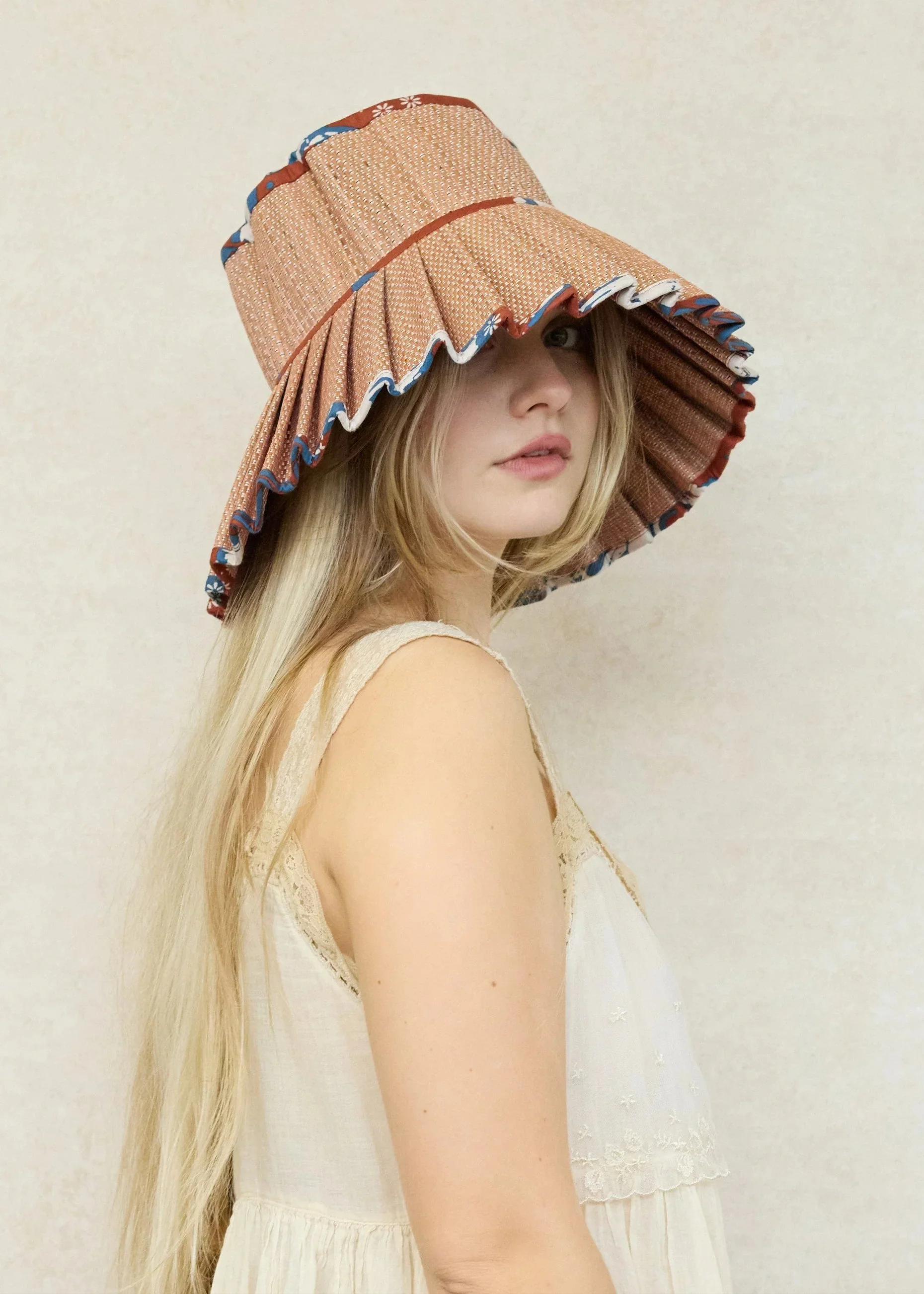 Coral Bay Island Capri Hat – handwoven foldable wide-brim sun hat in coral and neutral tones, available at Goosebump Hong Kong.