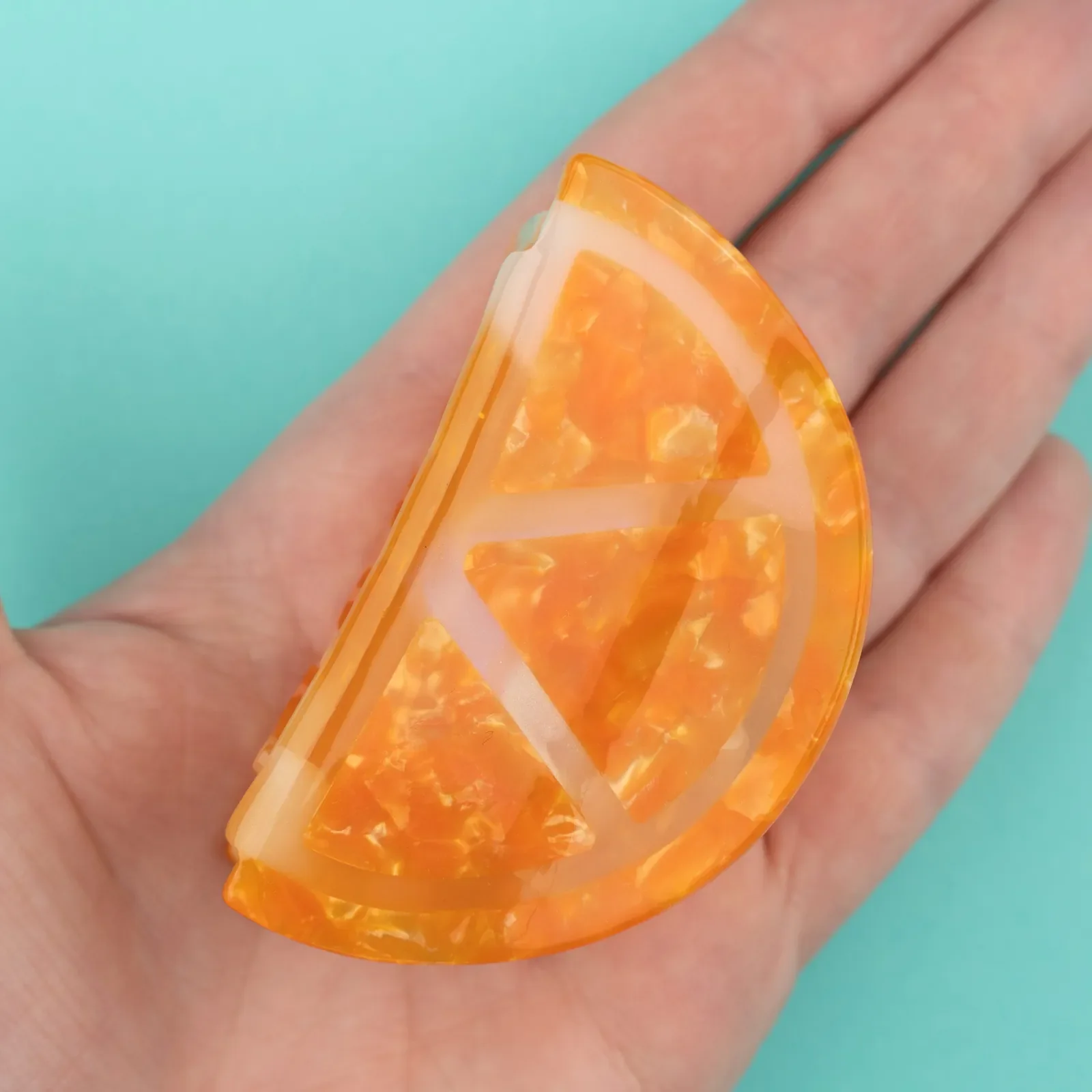Coucou Suzette Orange Hair Claw in glossy cellulose acetate, a cheerful French fruit-inspired hair accessory curated by Goosebump.