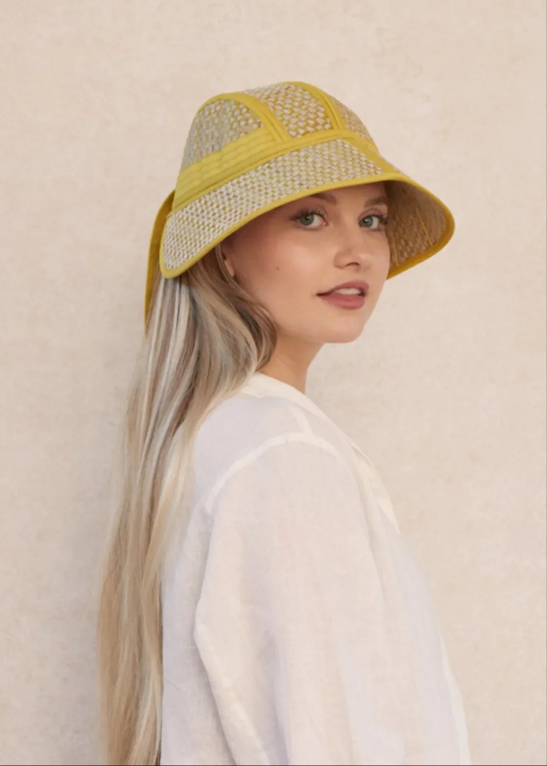Model wearing the Lorna Murray Tuscany Riviera Hat, showcasing its 1930s-inspired silhouette and flat mid-length brim.