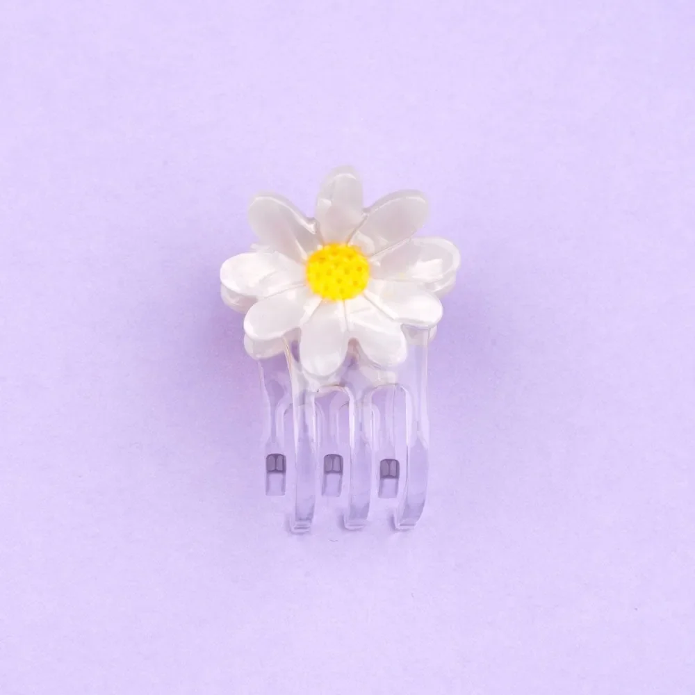 Coucou Suzette Mini Daisy Hair Claw in glossy cellulose acetate, a sweet French flower hair accessory curated by Goosebump.