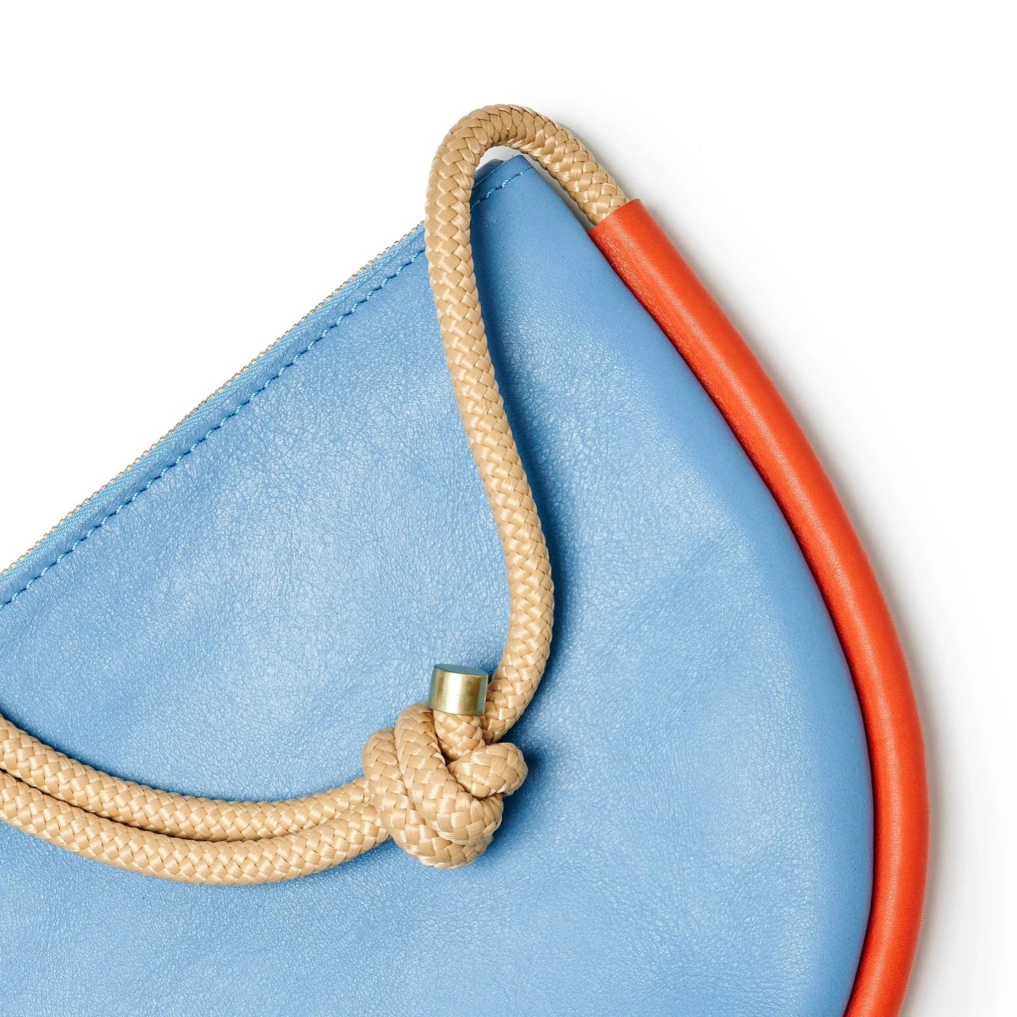 Selene Bag in sky blue and lobster red with folded silhouette, short handle and rope strap, handmade by Project Dyad in Cape Town.