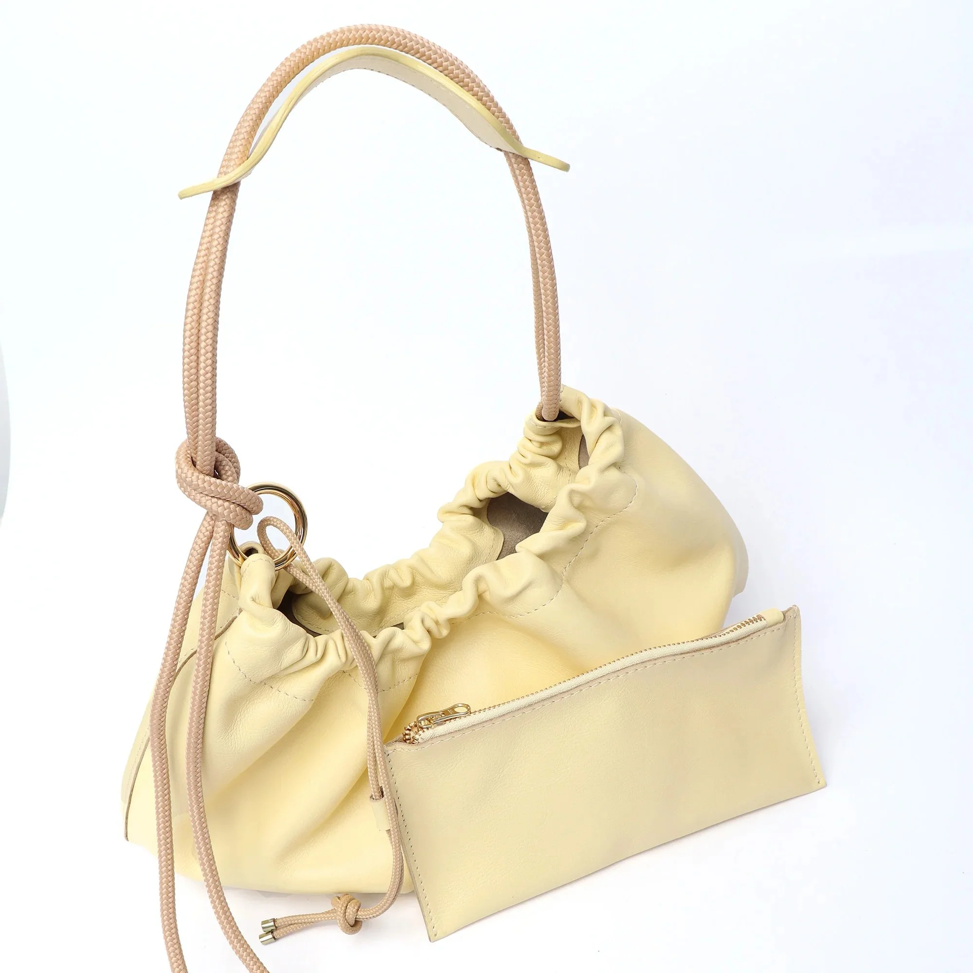 Butter yellow Flora Bag with tulip-style opening, handcrafted leather and adjustable rope strap by Project Dyad.