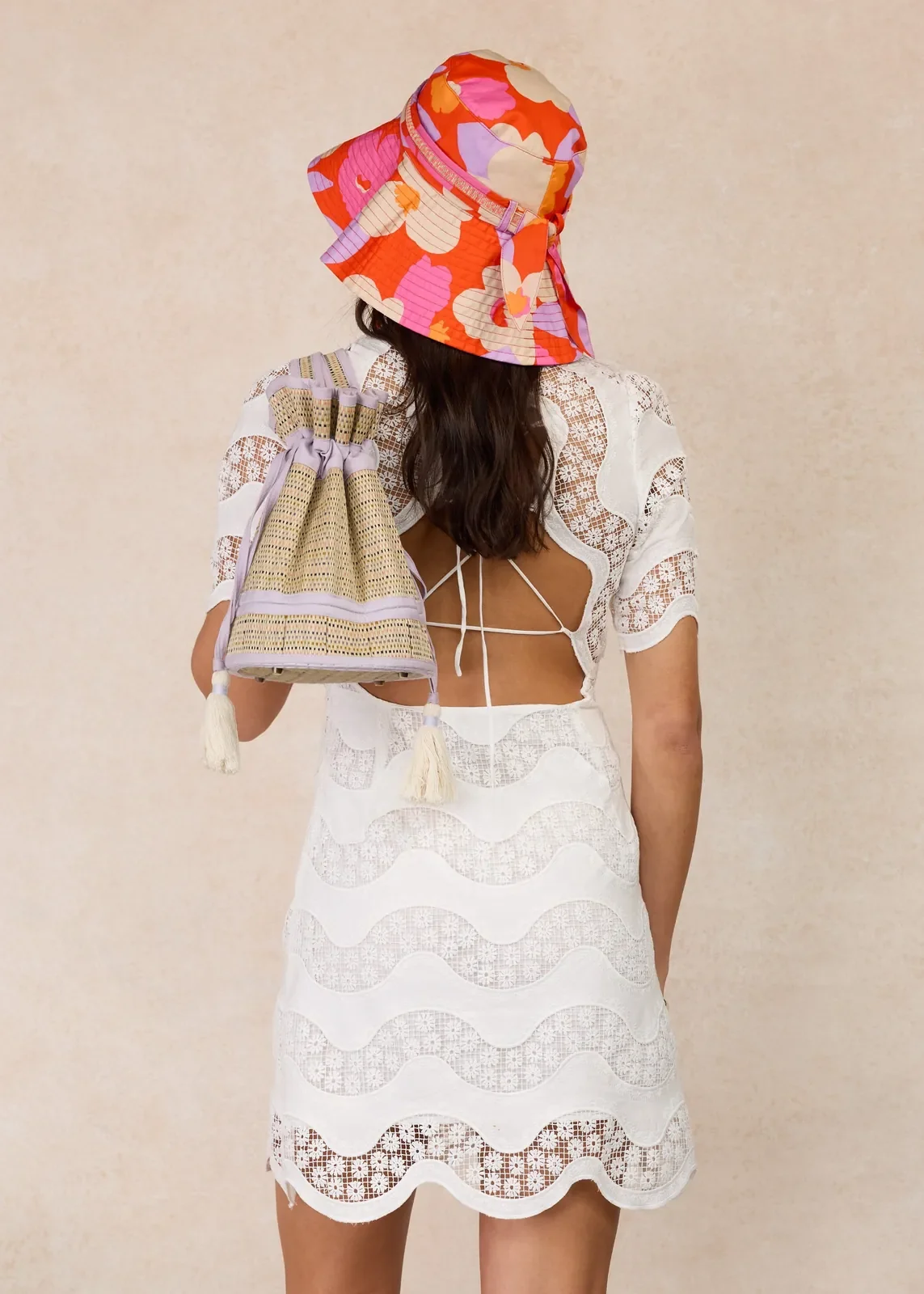 Model wearing the Lorna Murray Longboard Rottnest Island Bucket Hat from the back, highlighting its colourful floral print and wide-brim design.