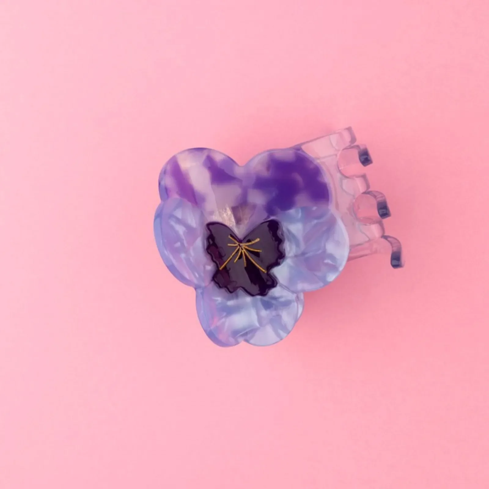 Coucou Suzette Pansy Hair Claw in glossy cellulose acetate, a delicate French flower hair accessory curated by Goosebump.