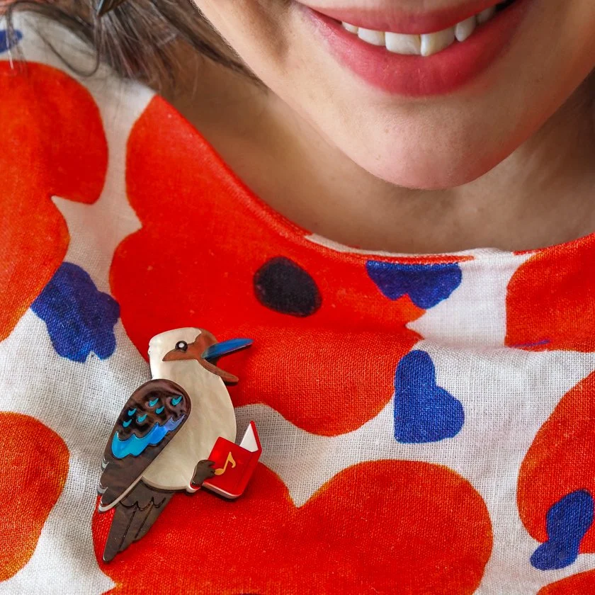 Erstwilder Kip the Kookaburra Christmas brooch singing with carol book, handcrafted layered resin design. Exclusive in Hong Kong at Goosebump.