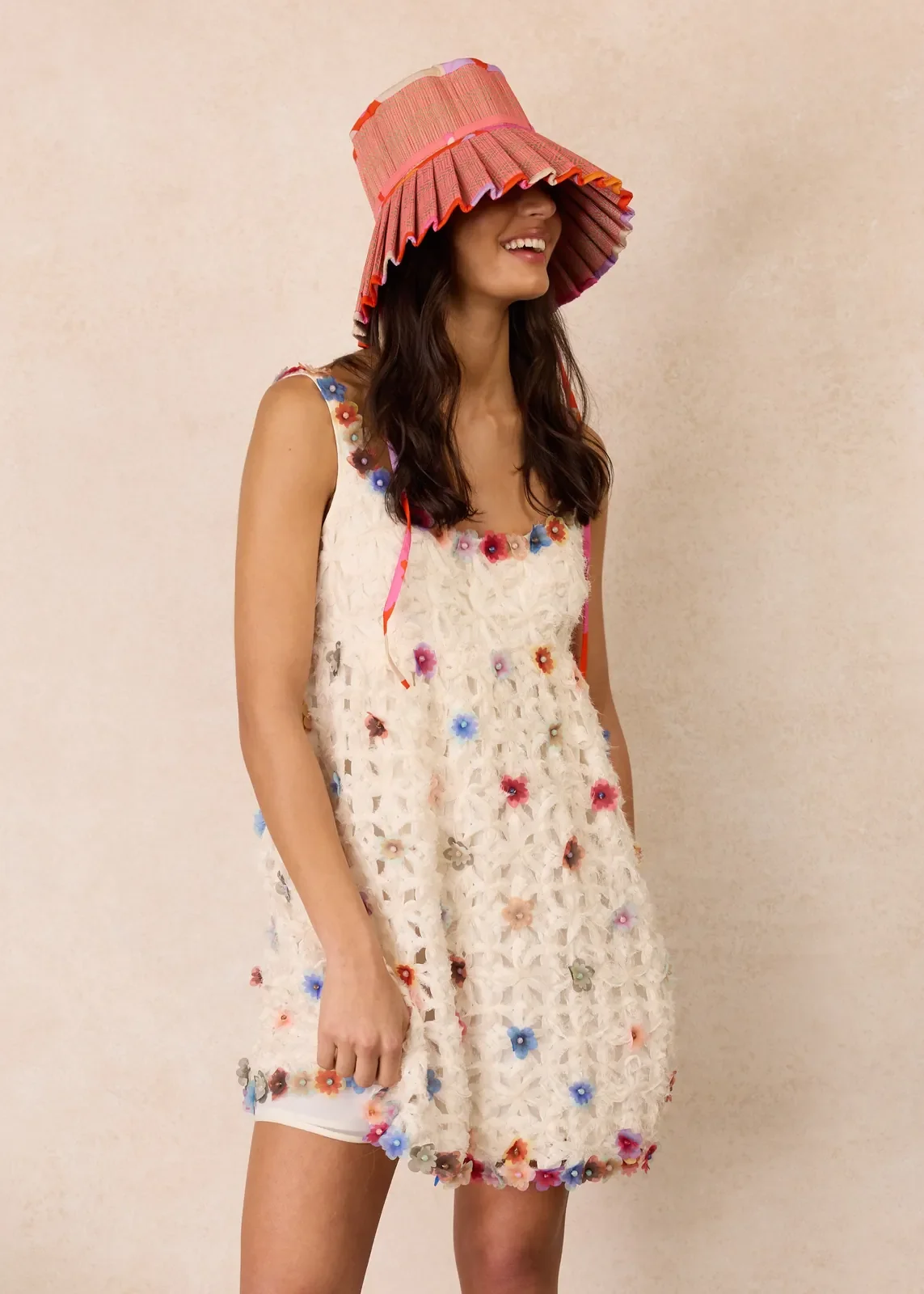 Model wearing the Lorna Murray Longboard Island Capri Play Hat, showcasing its wide pleated brim and colourful handcrafted details.
