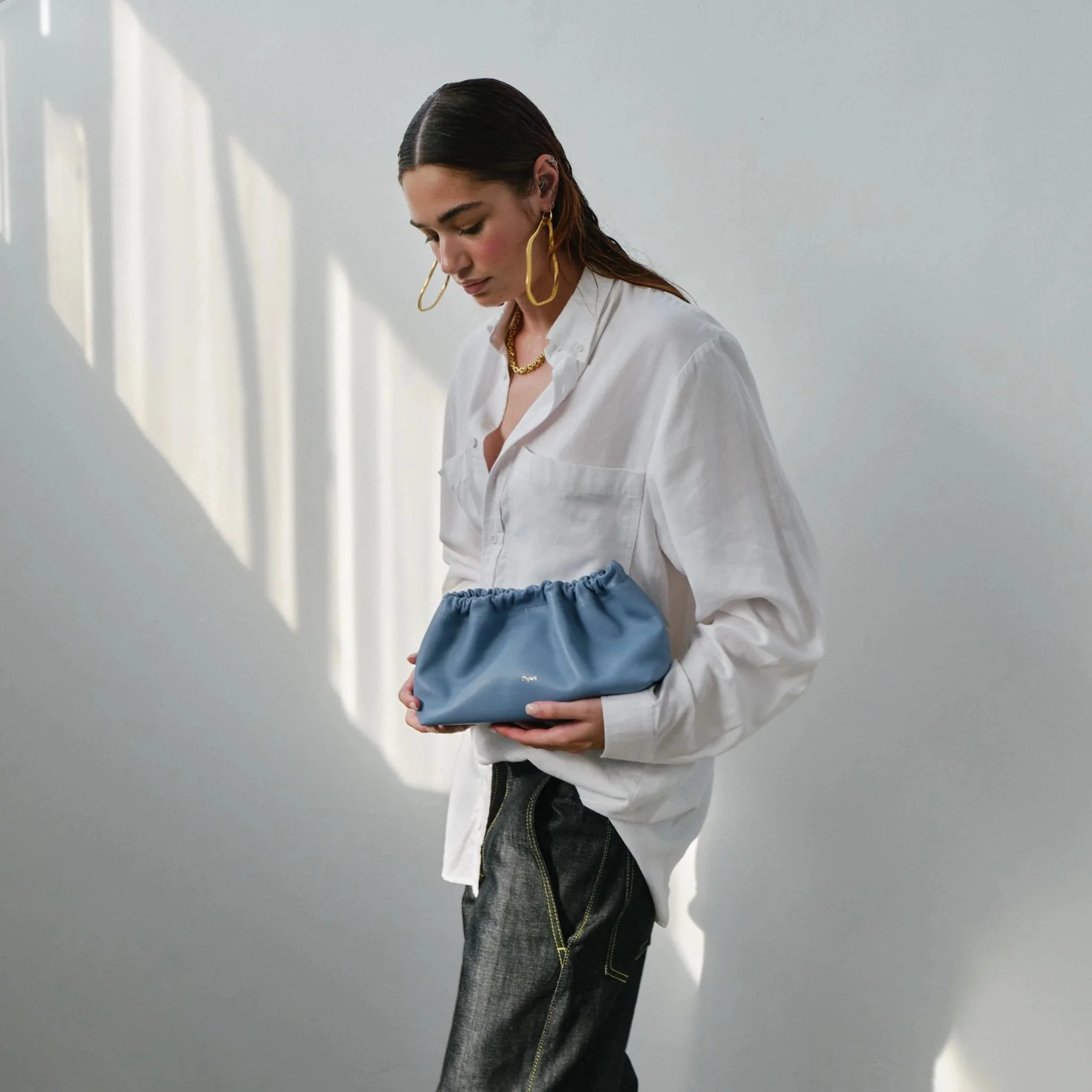 Wave Bag in sky blue with soft crescent shape, short handles and bonded cotton lining, handmade by Project Dyad in Cape Town.