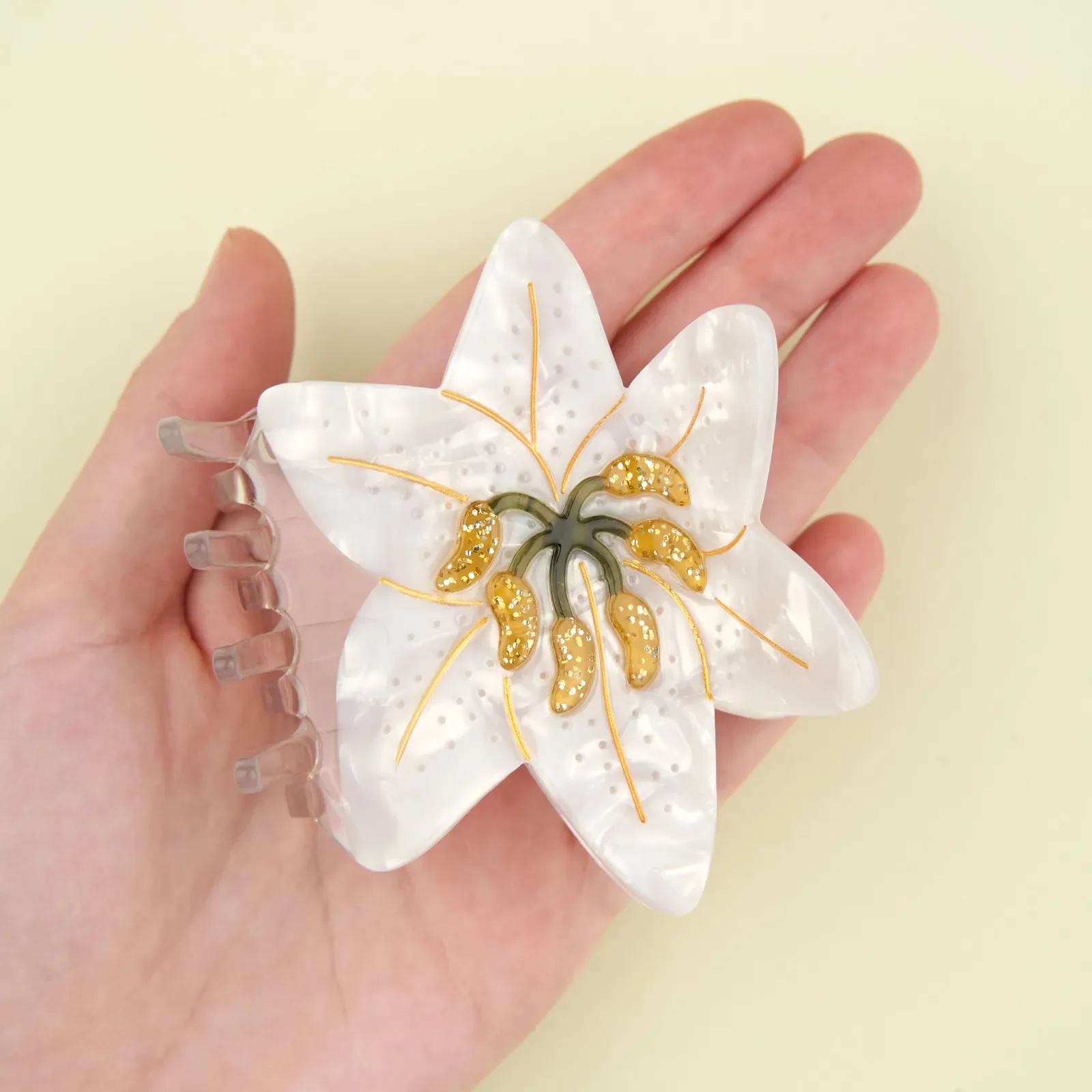 Coucou Suzette Lily Hair Claw in glossy cellulose acetate, an elegant French flower hair accessory curated by Goosebump.