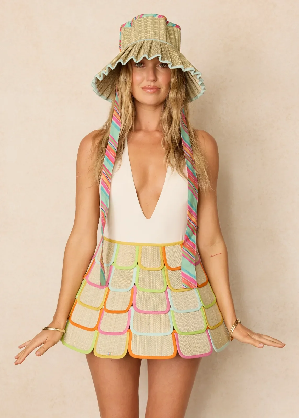 Model wearing the Lorna Murray Pool Float Pacific Luxe Ravello Hat, showcasing its lightweight handcrafted woven design and wide-brim silhouette.