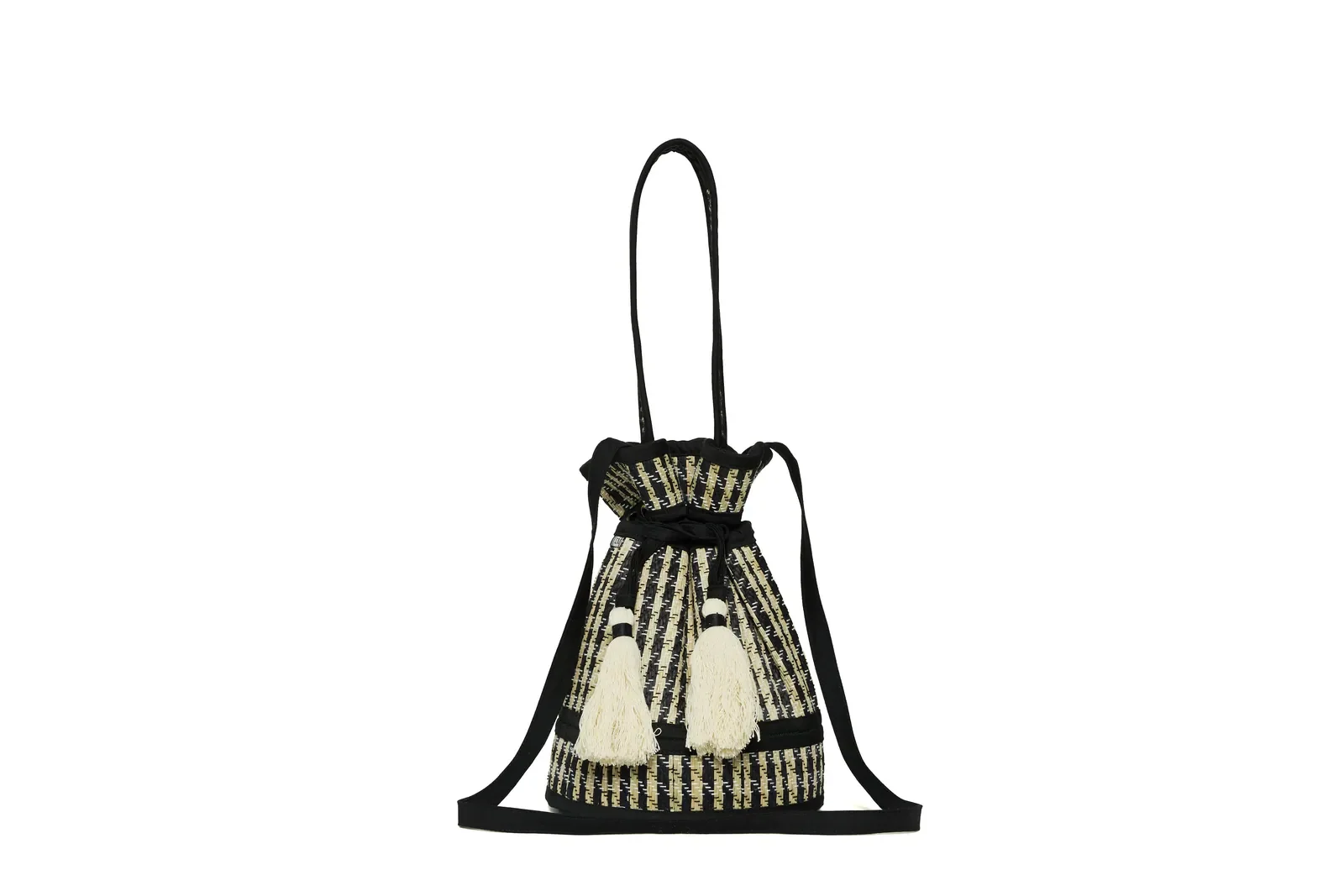 Angled front view of the Lorna Murray Roma Island Mini Leisure Tote highlighting its handcrafted woven design, crossbody strap and cotton tassel.