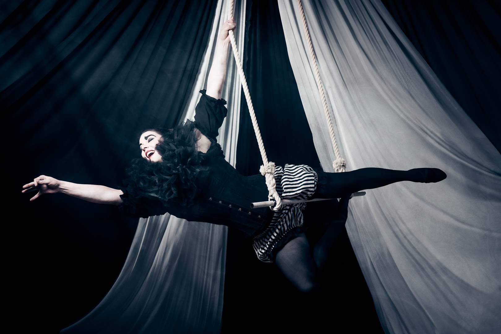 Pierrot styled circus tent shoot with smoke , trapeze dance photography with Snake, Star and Skull professional photography