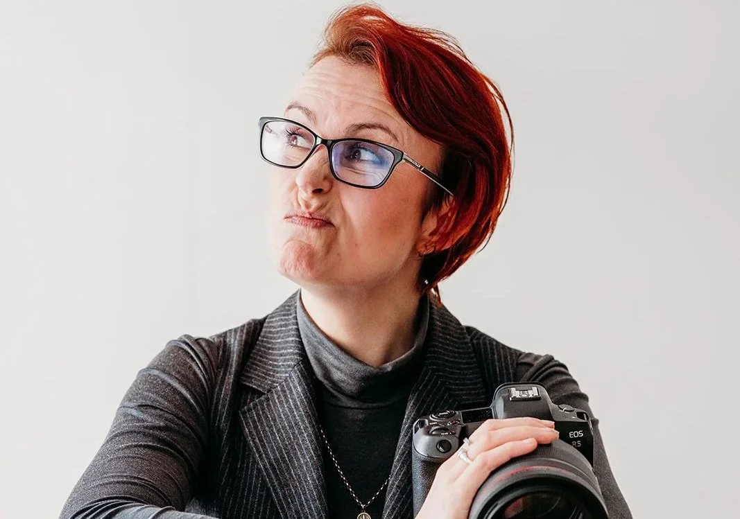 Photo of photographer Sian Tyrrell making a funncy face and holding her camera - taken by Hester Barnes