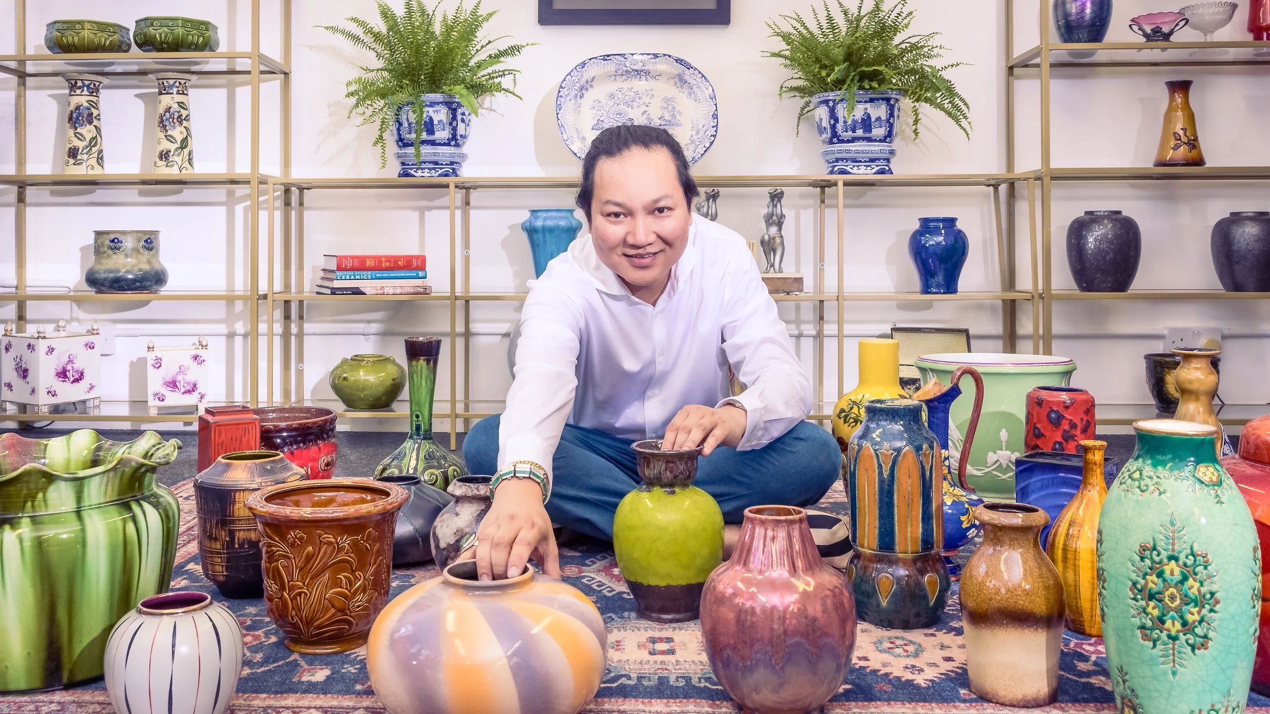 Antiques expert Curiosities by Simplicio photographed surrounded by his collection of vases shot by Sian T. Photography, Esher, Surrey