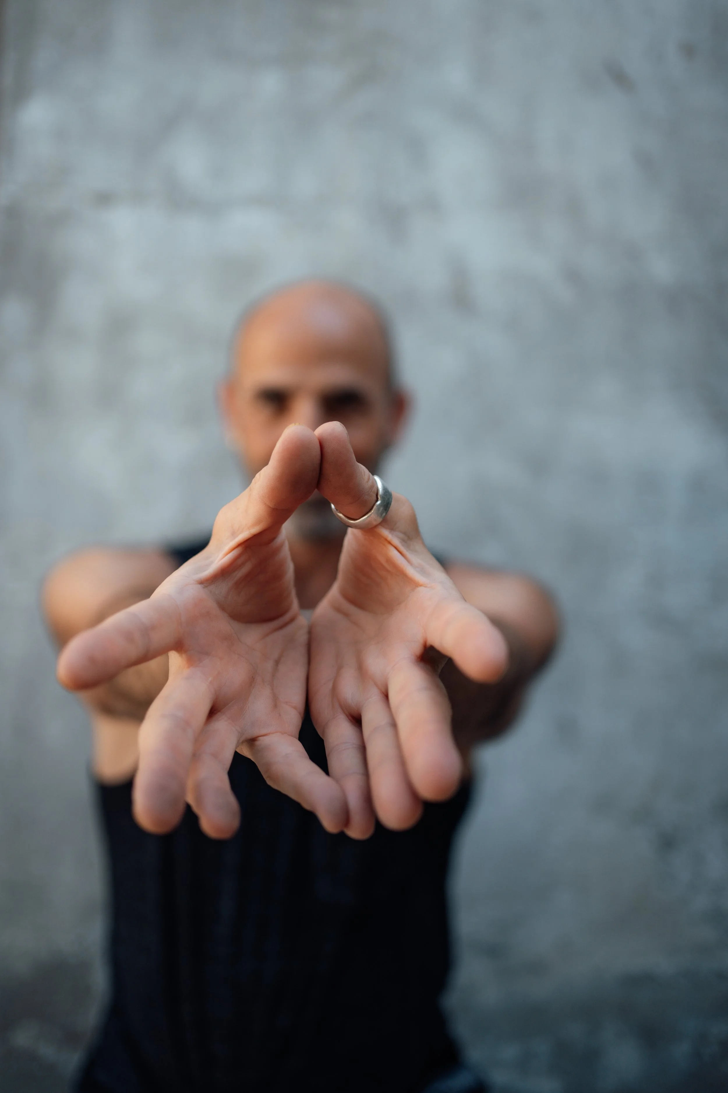 David Schlussel with hands in lotus mudra coming toward you.