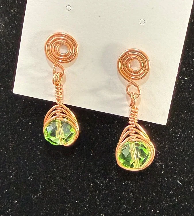 805-26;Earrings;’BCuStudSpiralHoldingPaleGreenBead’;UniqueHandCraftedFreeForm;BCuClosedSpiralStud;SuspendingAUniqueHandCraftedFreeFormBCuUpwardAlternatingHalfVerticalSpiralWireWrapDongleHoldingAGorgeousPaleGreenFacettedRoundCrystalBead;NoEarHookRequi