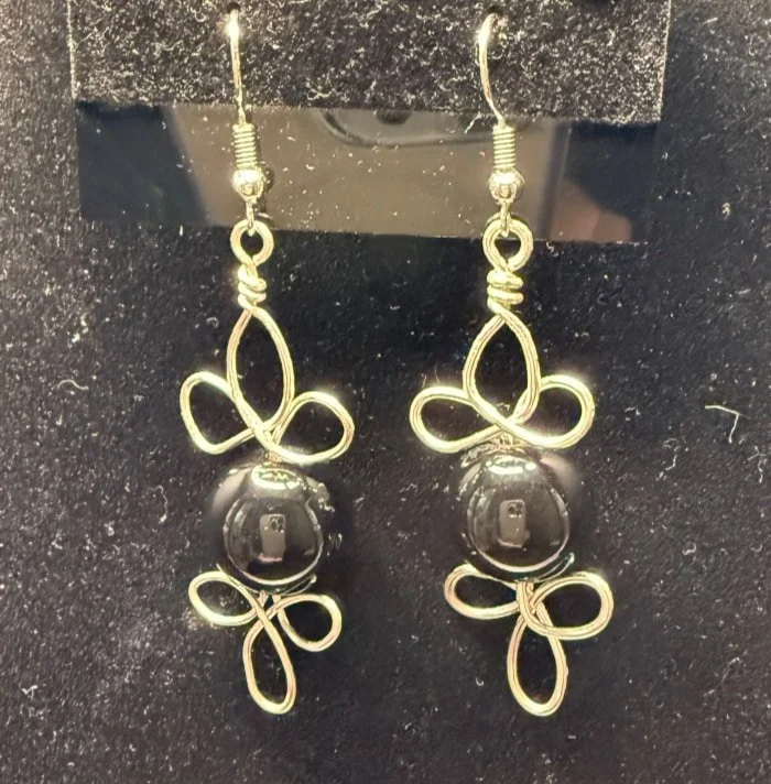 839-26;Earring:”Fancy Flourished DeepBlackBead”,HandCraftedFreeFormDesign
In Round Ag Wire Of TripleLoopsTopandBottom SurroundingABeautifulSolidBlackBead; Ear Hooks AreAgBallAndSpring.(1 of 2)