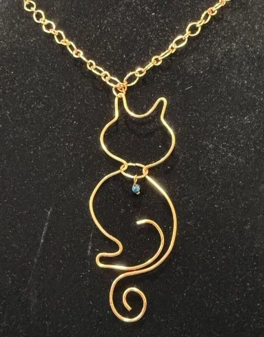 782-26;Necklace;’BriteCuKittyKatWithBlueCrystalOnNeckCollar’;AnOriginalJonMichelleDesign;UniqueHandCraftedFreeFormBriteCuRoundWireKittyKatShilouetteWithBlueCrystalSeedBeadOnNeckCollar;PlayfulCatPerchedReadyToJumpAndPlay;Chain24InchBriteCuAlternatingT