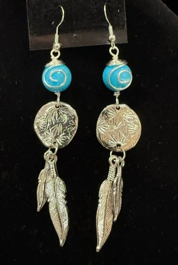 843-26;Earring:;'AgSantaFeBlueBeadWithFeatherAdornedTexturedDisc';OriginalJonMichelleDesignDDesign;HandCraftedFreeFormDesignInRoundAgWireWithAUniqueWireWrappedDesignOnABlueAgateBeadHoldingADoubleFeatherAdornedAgTexturedDisc;EarHooksAreAgWithBallAndSp