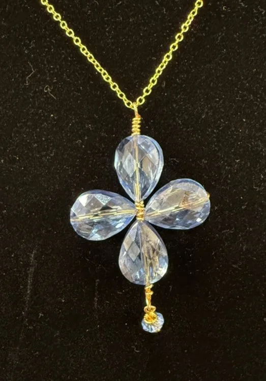 795-26;Necklacde;’PaleBlueCrystalRunicCross’;AUniqueRunicCelticCrossUsing;BeautifullyFacettedPaleBlueTearDropCrystalBeadsIsWrappedTogetherWithAuRoundWire;ALovelyTrapizoidalPaleBlueDropHangsFromTheBottomOfThisExquisitePeace;Chain24Inch;AuOfDelicatTiny