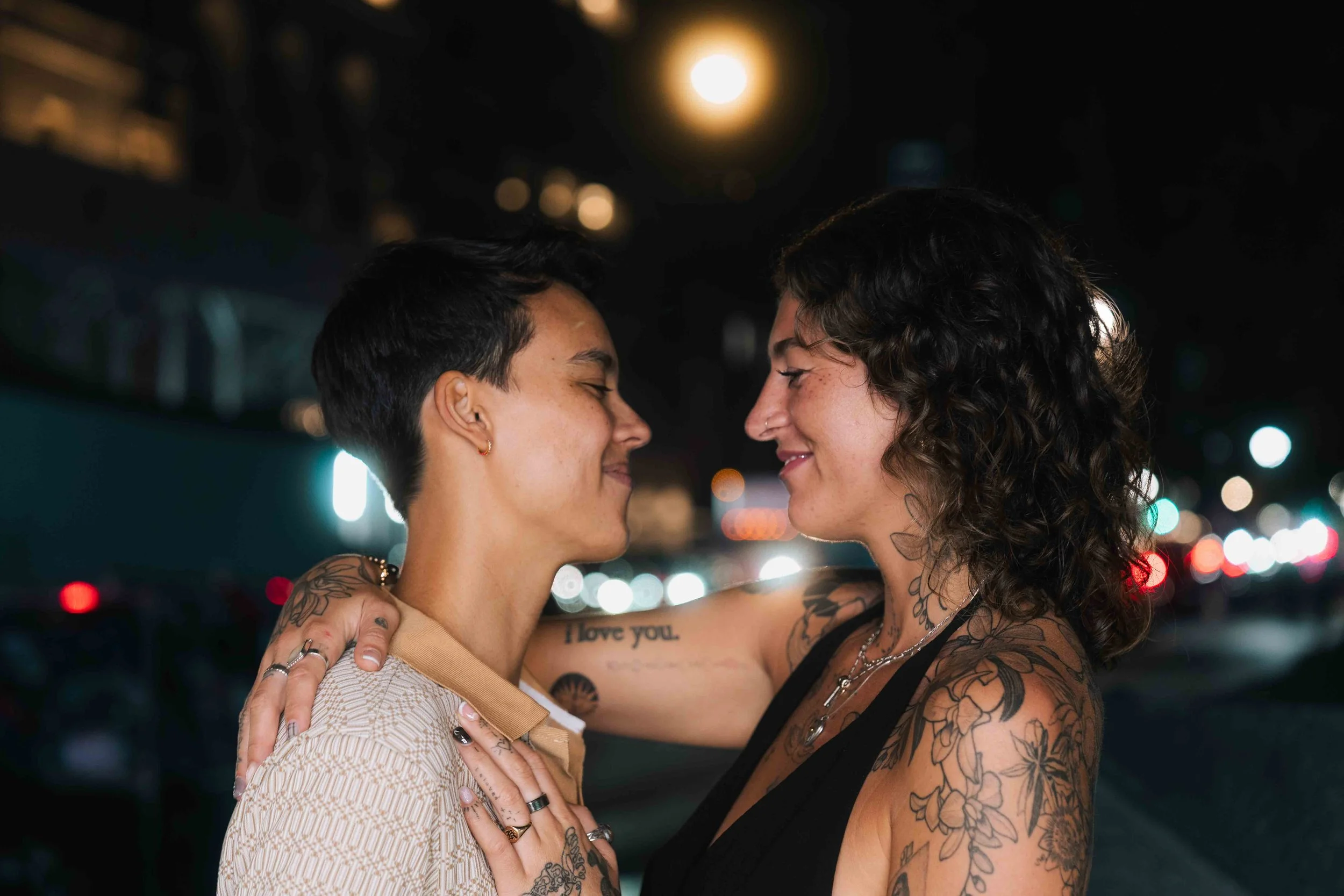 Scenic view of a lake surrounded by green hills and tall mountains.