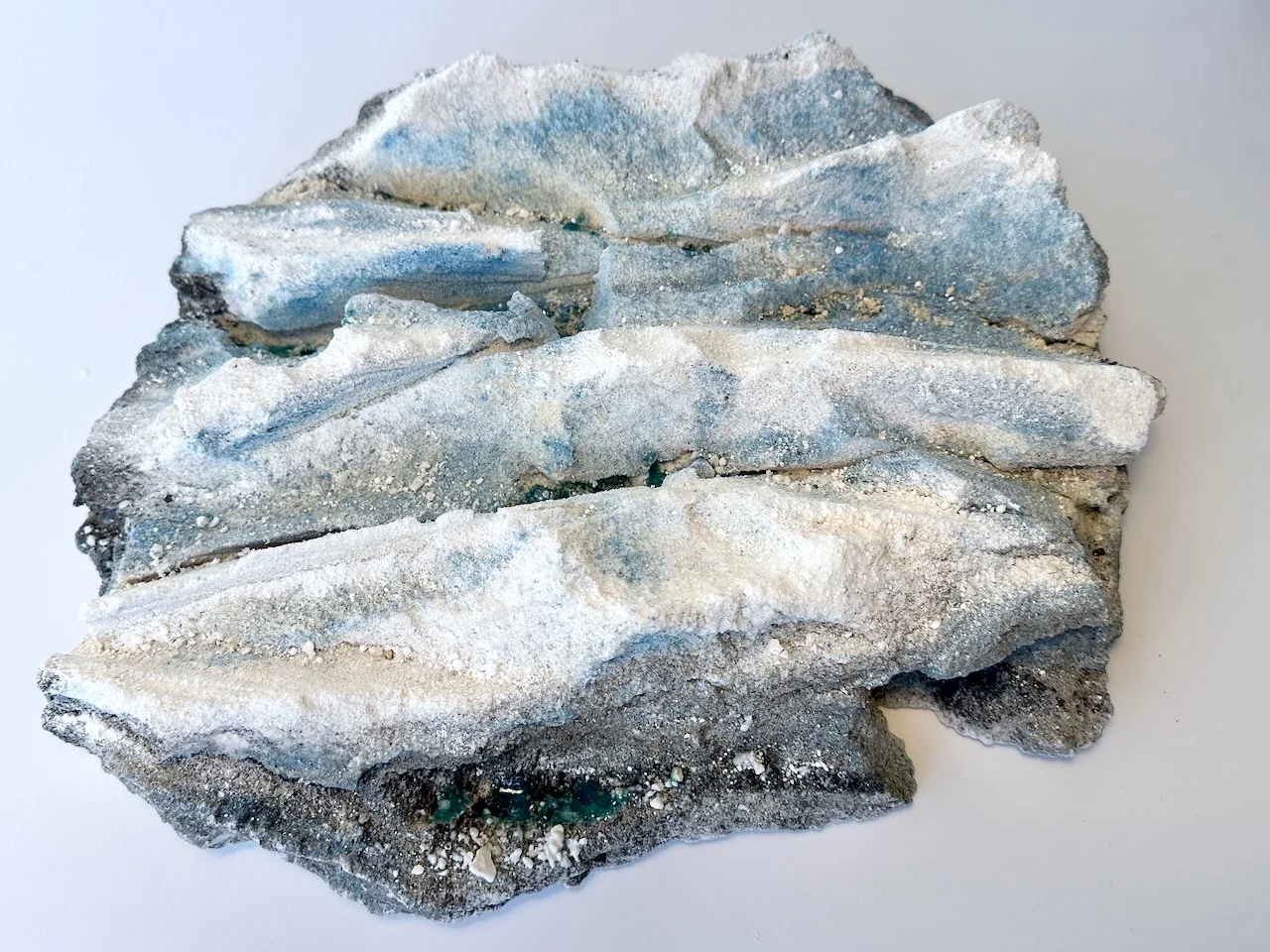 Glacial Witness - Finalist Waiclay 2025 Exhibition. Porcelain, dry glaze, stain and glass frit. 	10 x 39 x 37 cm.
