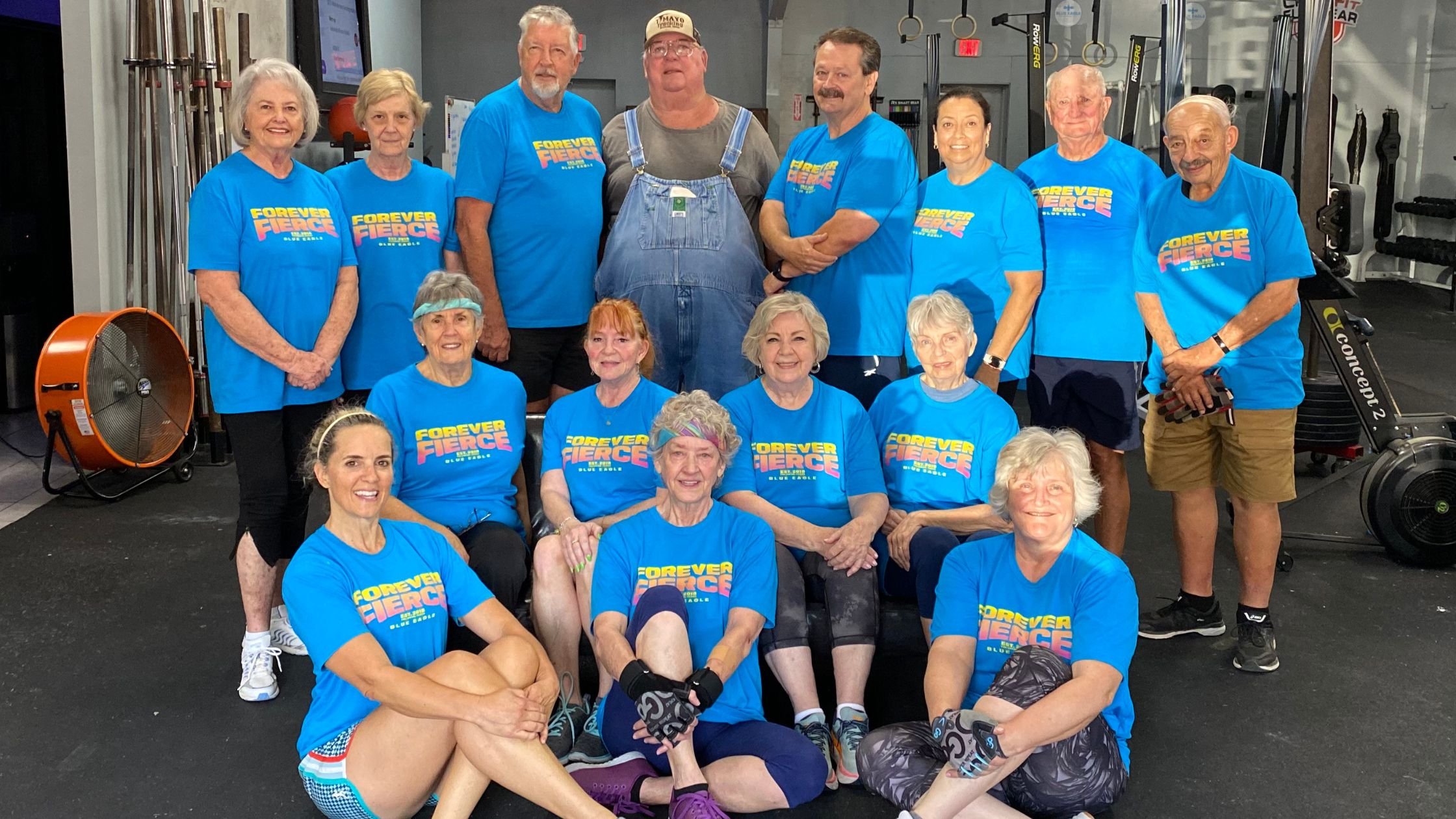 Group of older adults wearing matching Forever Fierce shirts during a senior fitness class focused on strength, mobility, and staying independent.