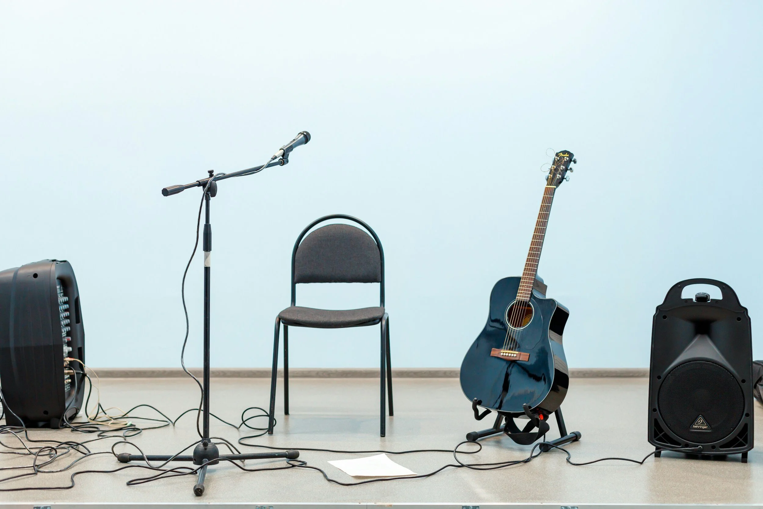 microphone, guitar, speakers and chair
