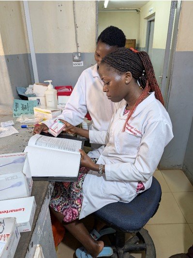 Pharmacy staff reviewing new counseling sheets 